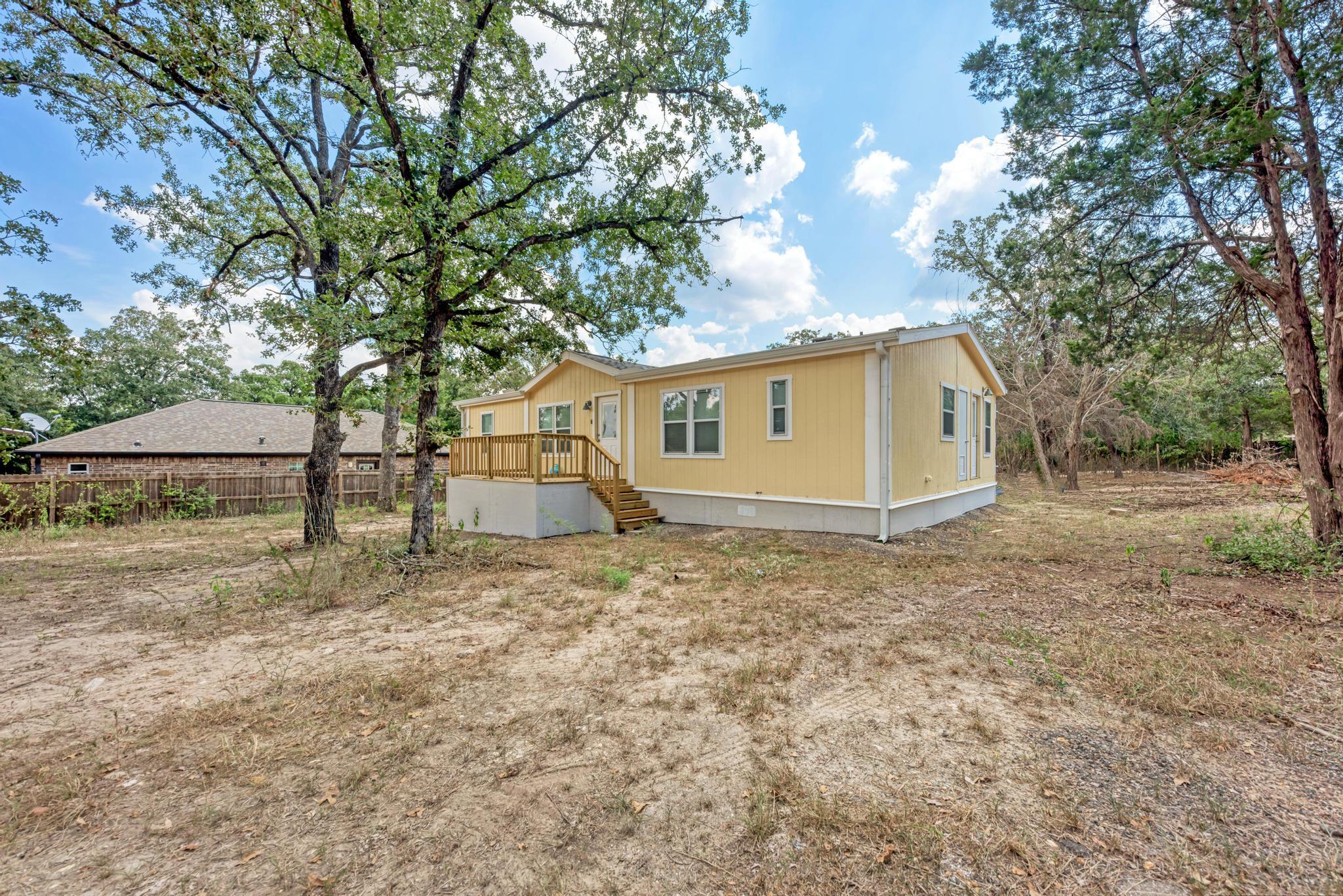 Mature trees surround this classic siding home fe