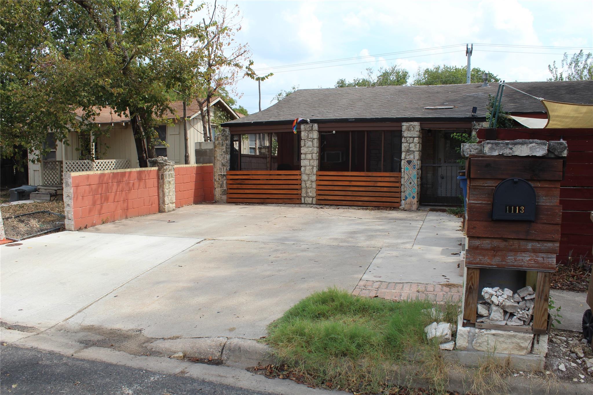 A spacious concrete driveway leads to a classic h