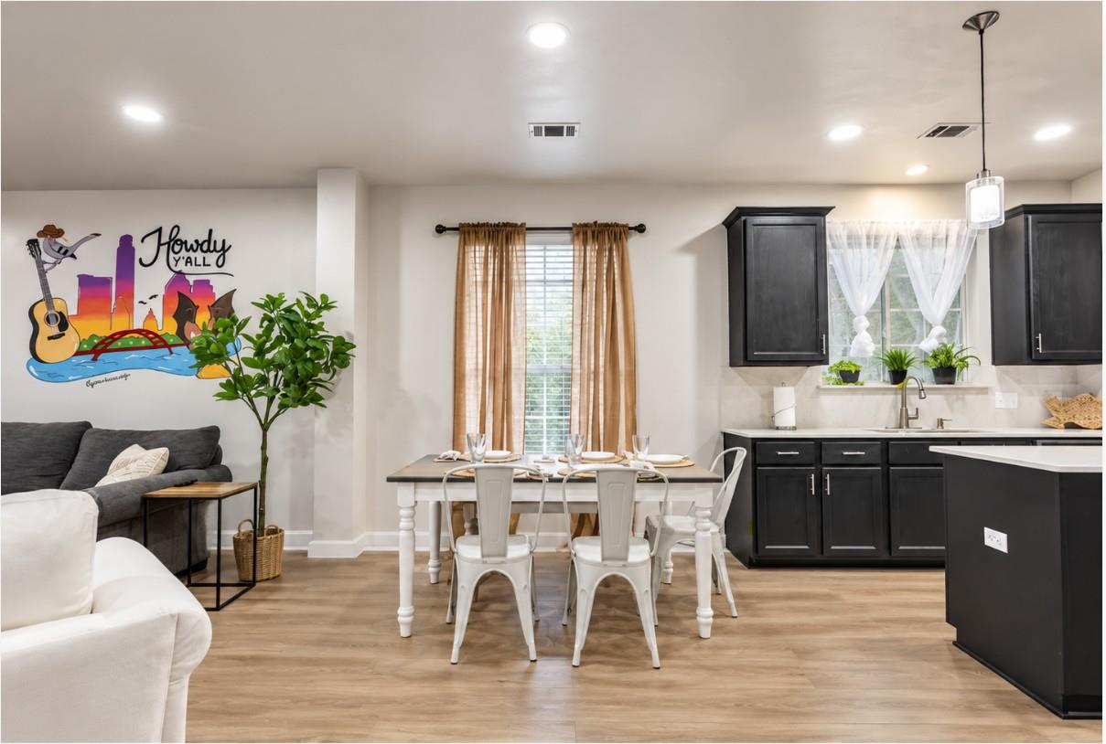 Warm wood flooring flows through this open concep