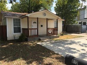 Mature trees shade a welcoming front porch and cl