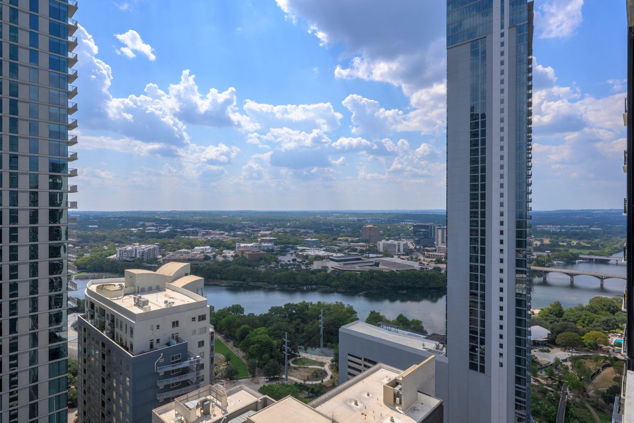Gaze across the winding river and city skyline fr