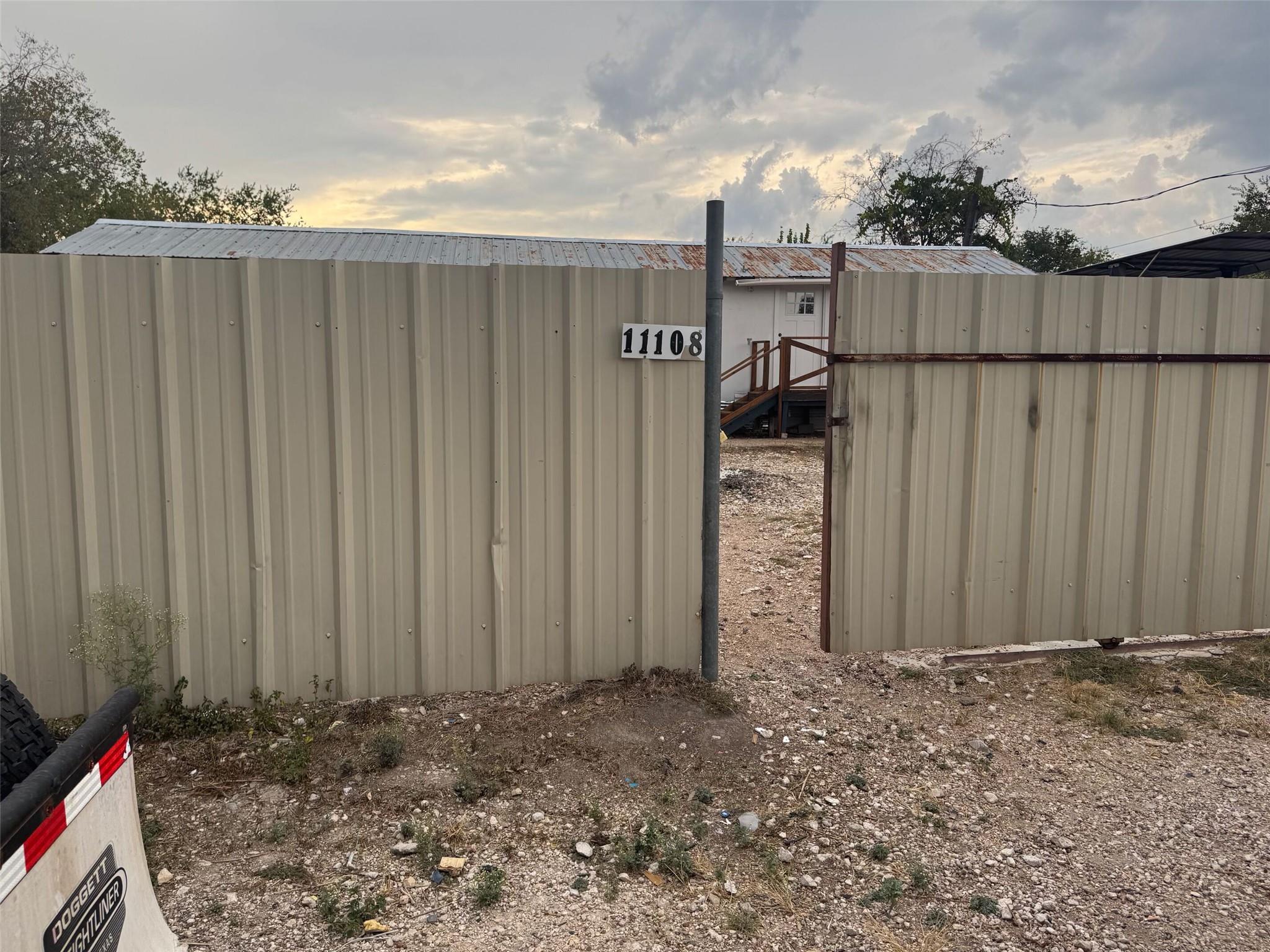 A metal privacy fence secures the perimeter of th