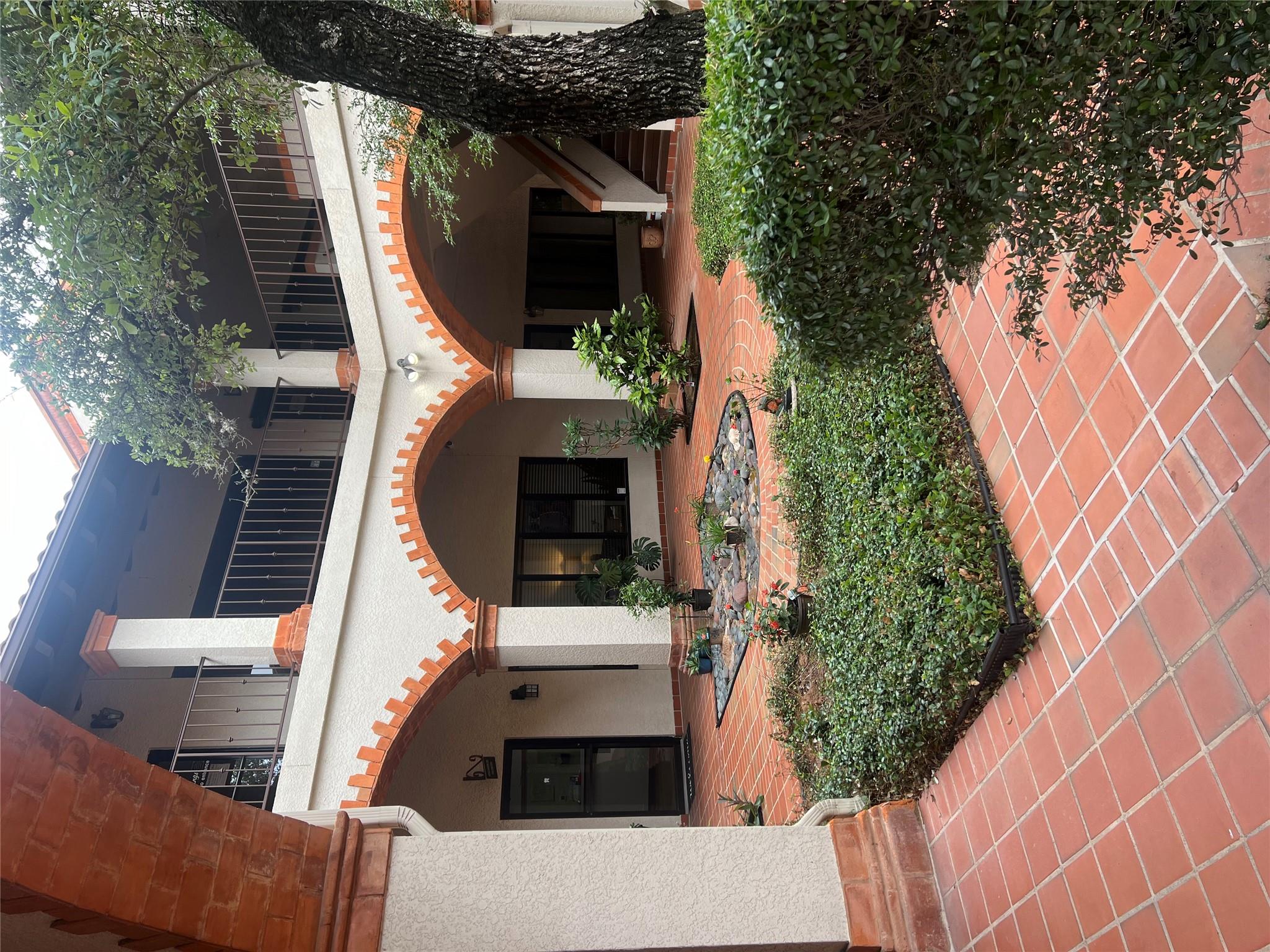 A tranquil Mediterranean-style courtyard features
