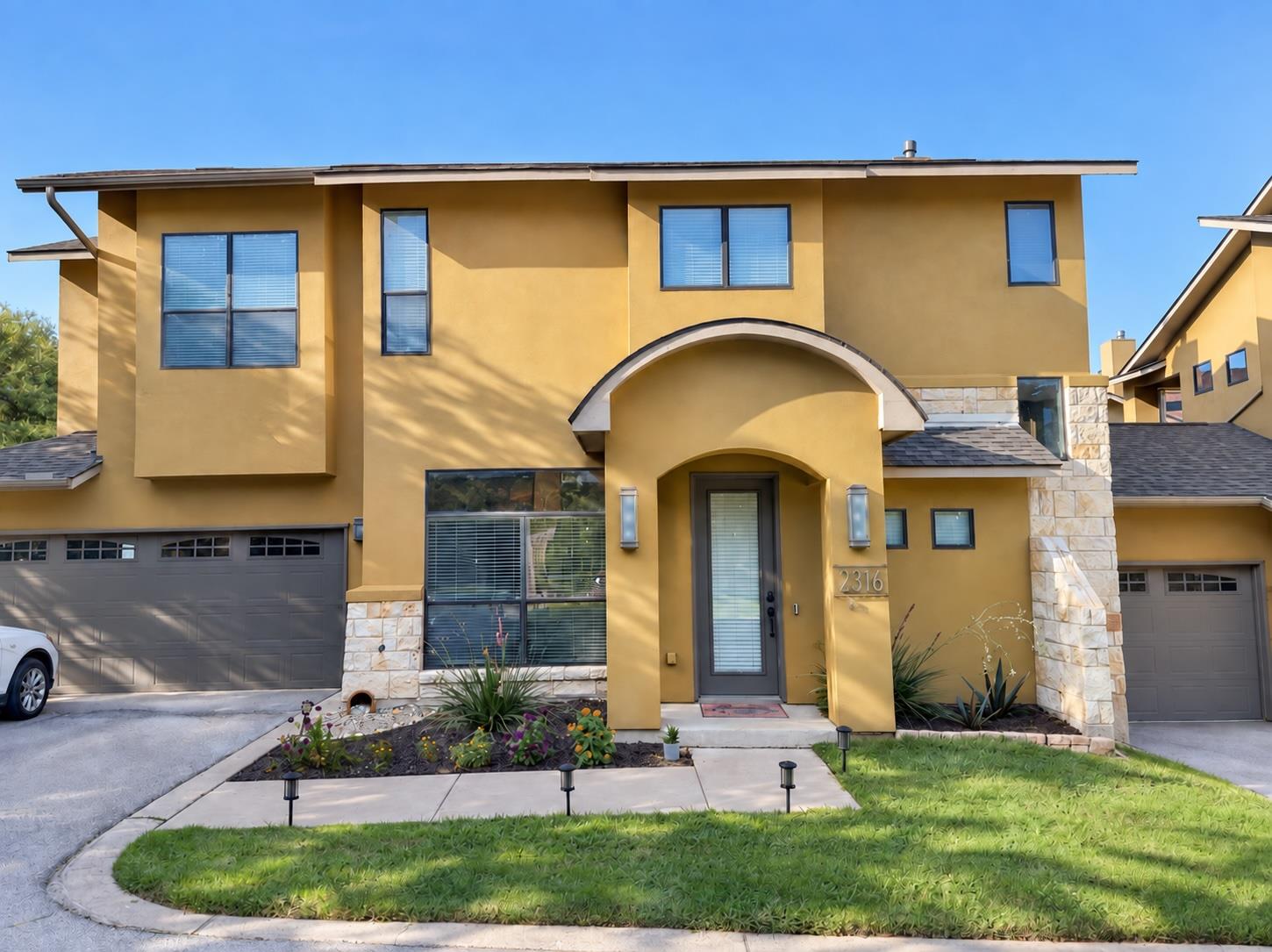 A classic stucco exterior features stone accents 