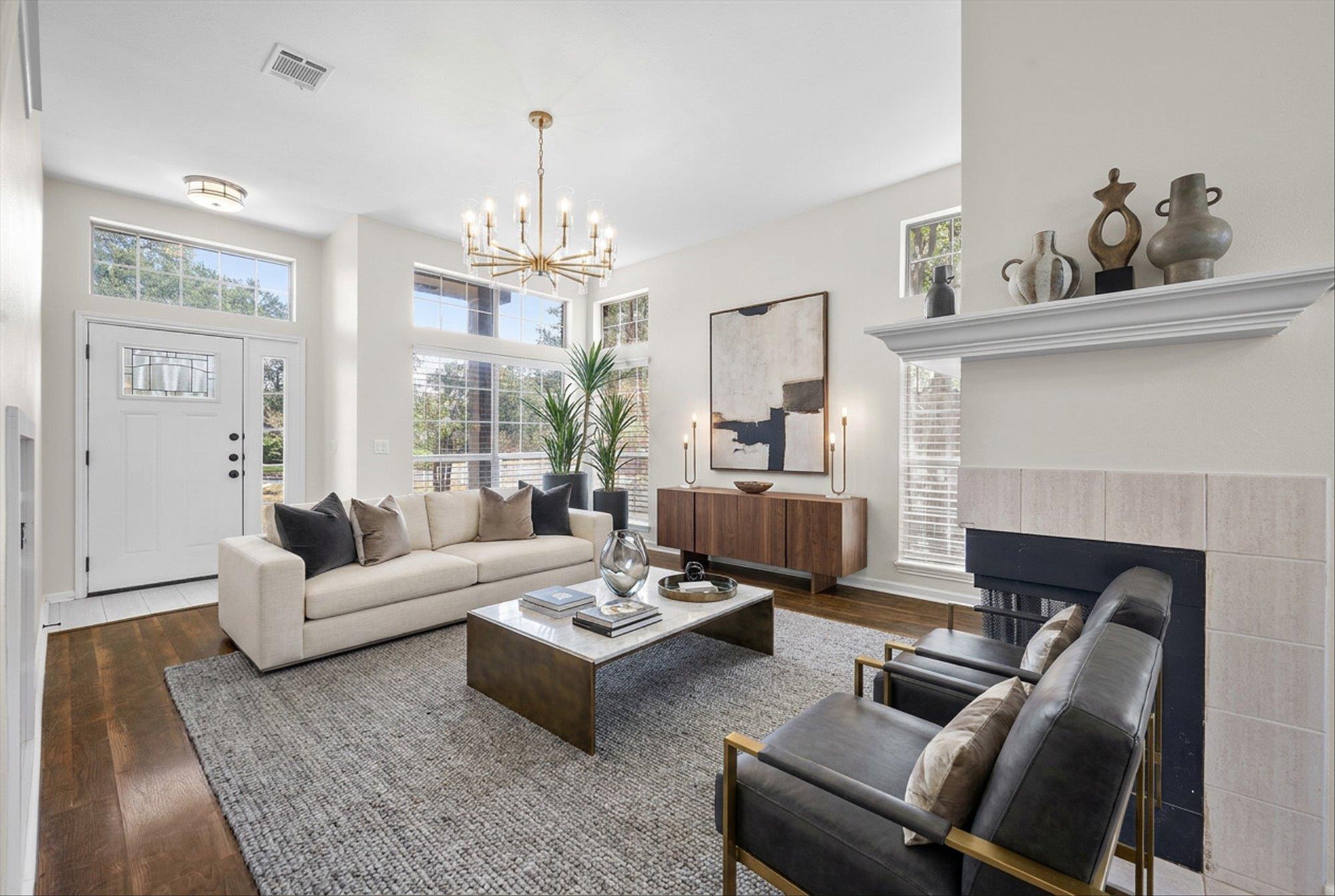 Rich hardwood floors and a tile fireplace anchor 