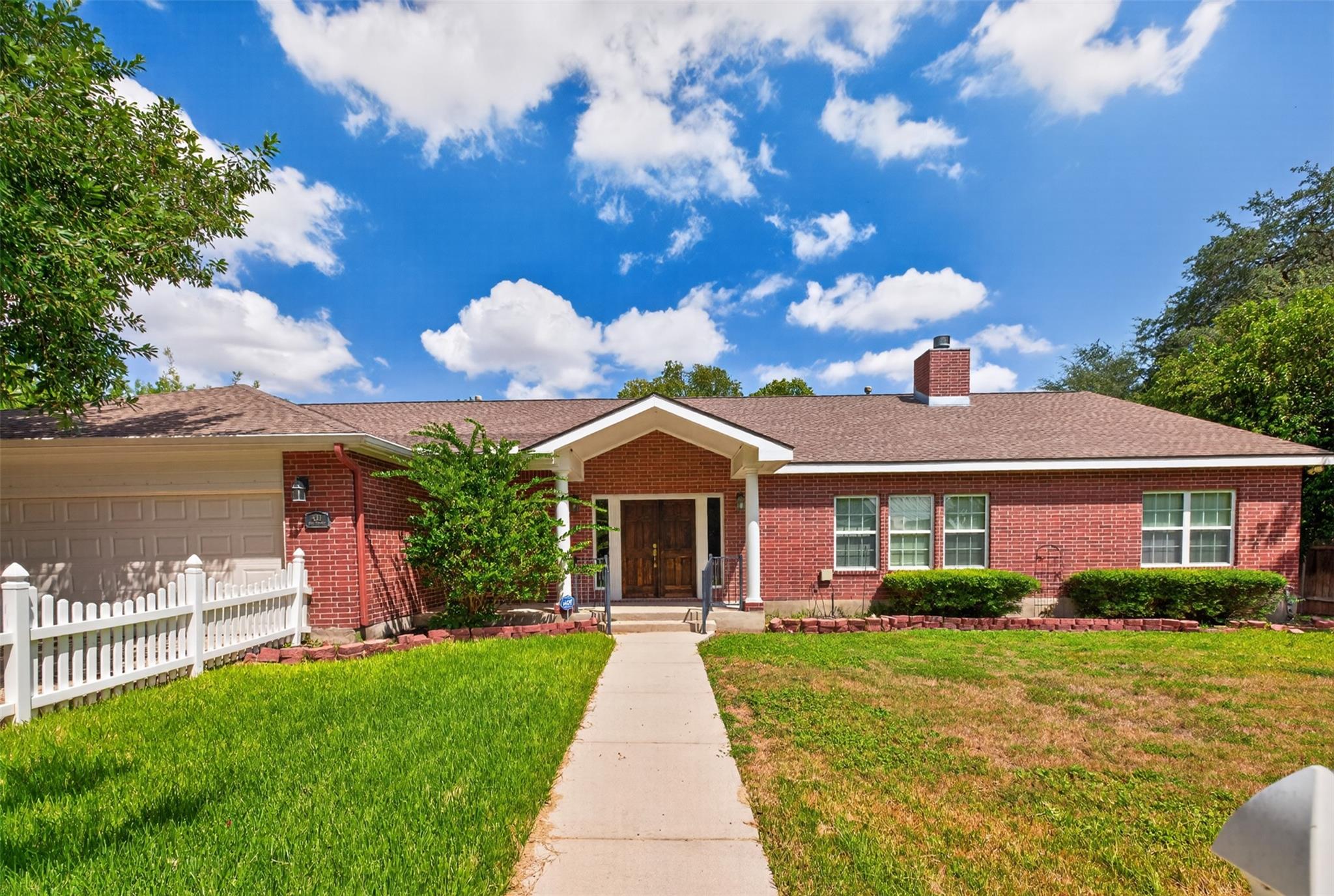 A paved walkway leads past neat lawns to the clas