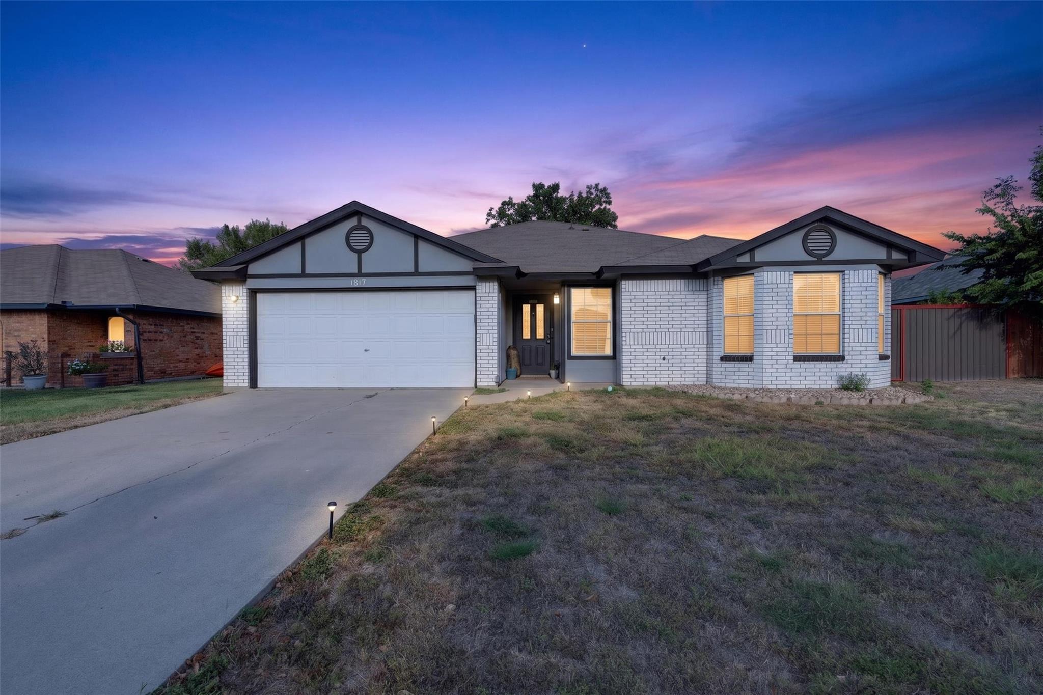 Crisp masonry accents and a multi-gabled roofline