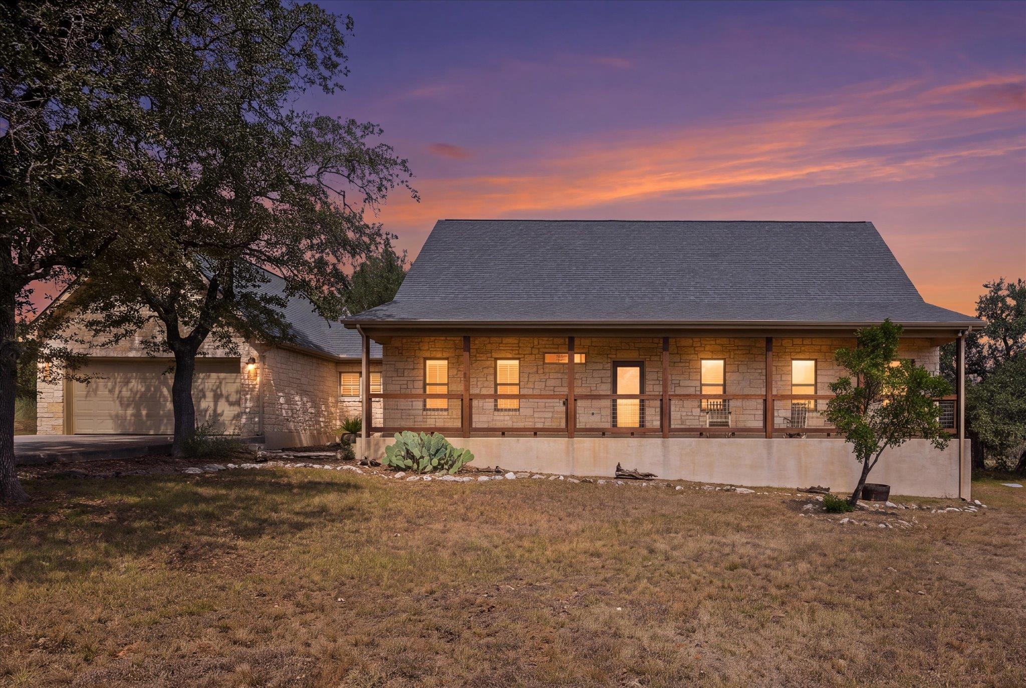 A classic stone facade and covered front porch se