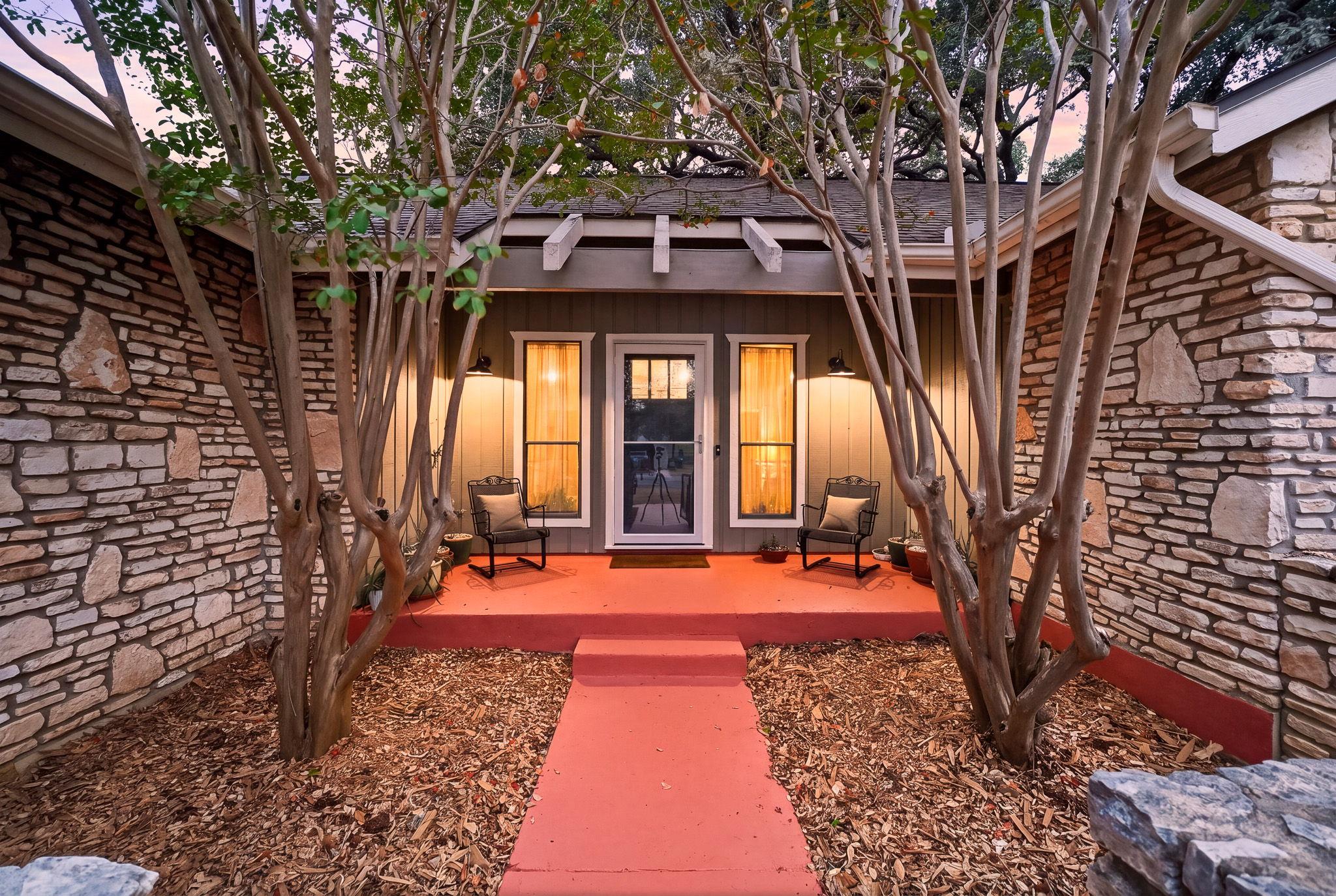 Natural stone masonry frames a welcoming front po