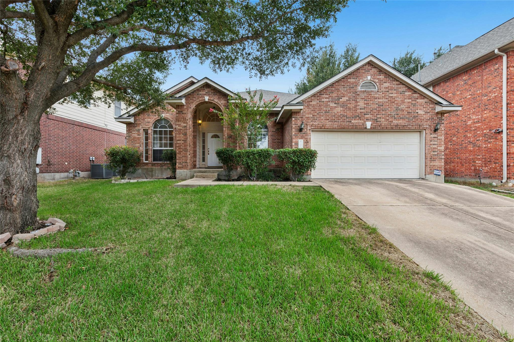 Classic brick exterior and a neat concrete drivew