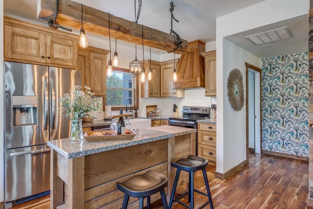 Exposed timber beams and warm wood flooring bring