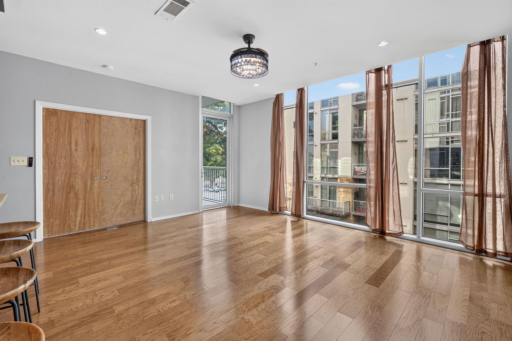Floor-to-ceiling windows frame neighborhood views