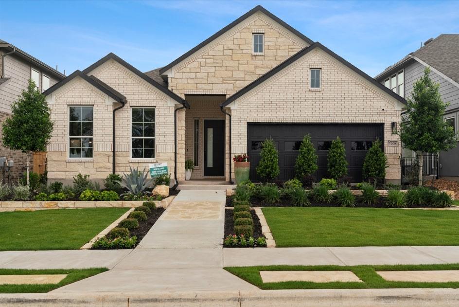 Crisp masonry accents and manicured lawn detail t