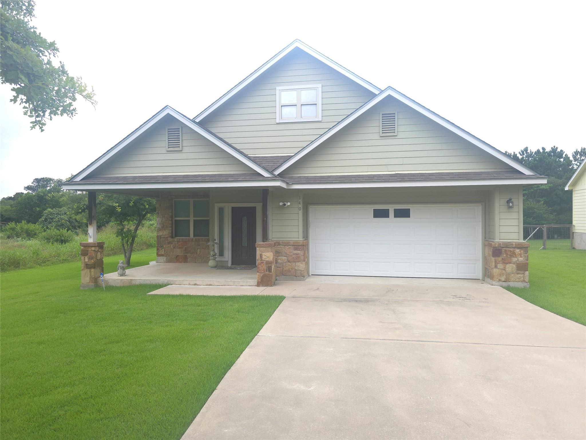 A welcoming residence featuring stone accents and