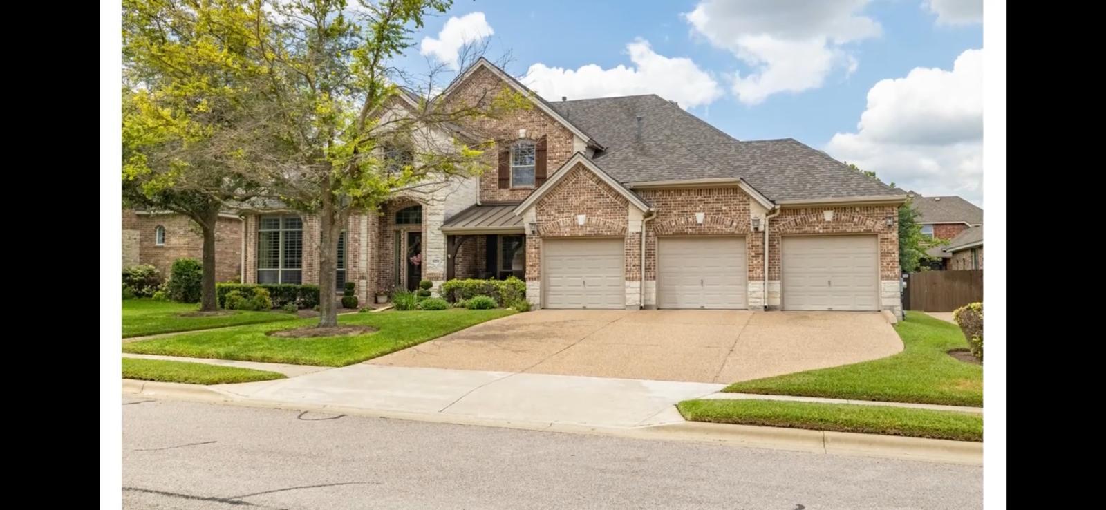 A classic brick exterior and a three-car garage a