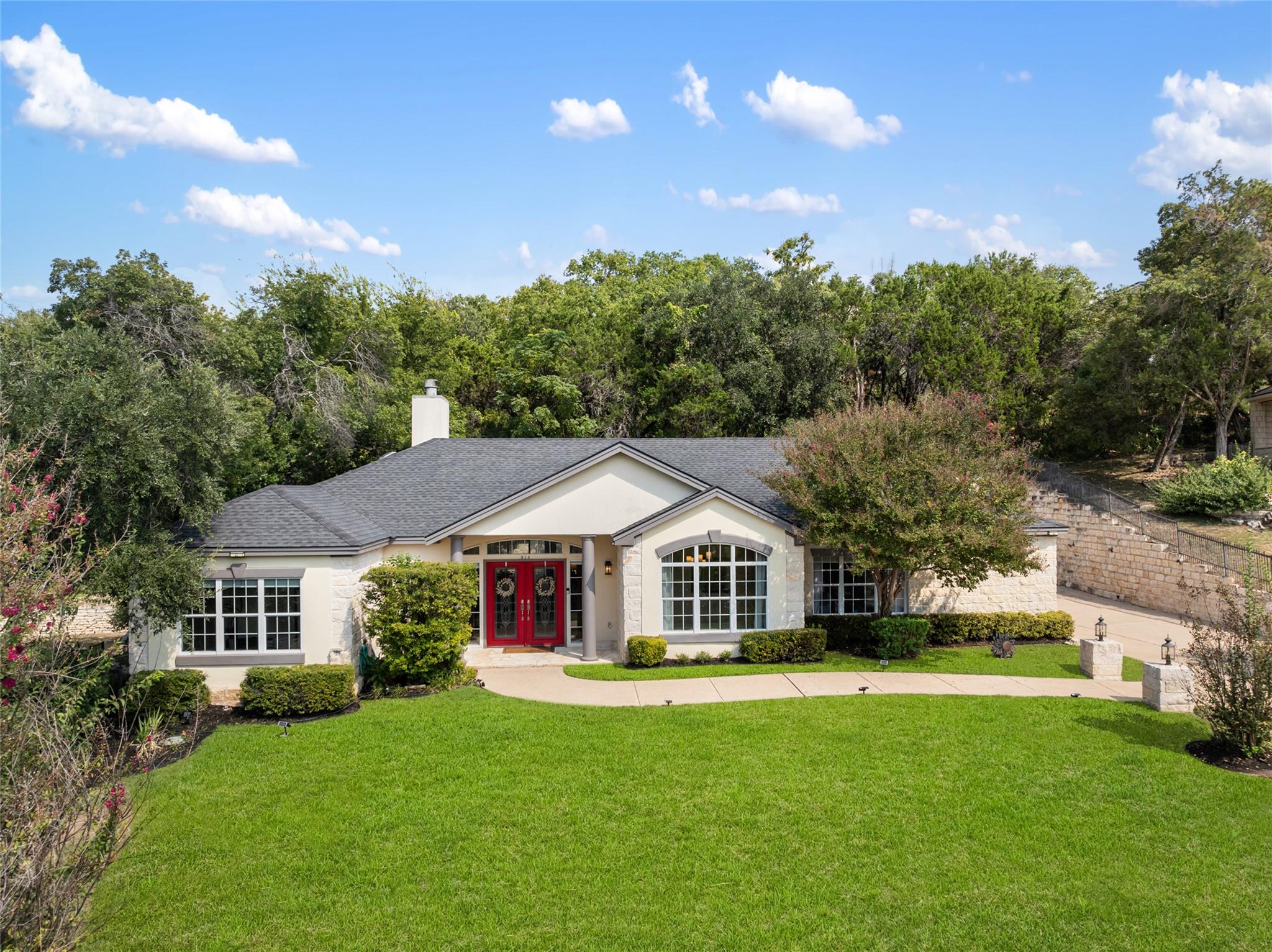 Manicured lawns and classic stone accents frame a