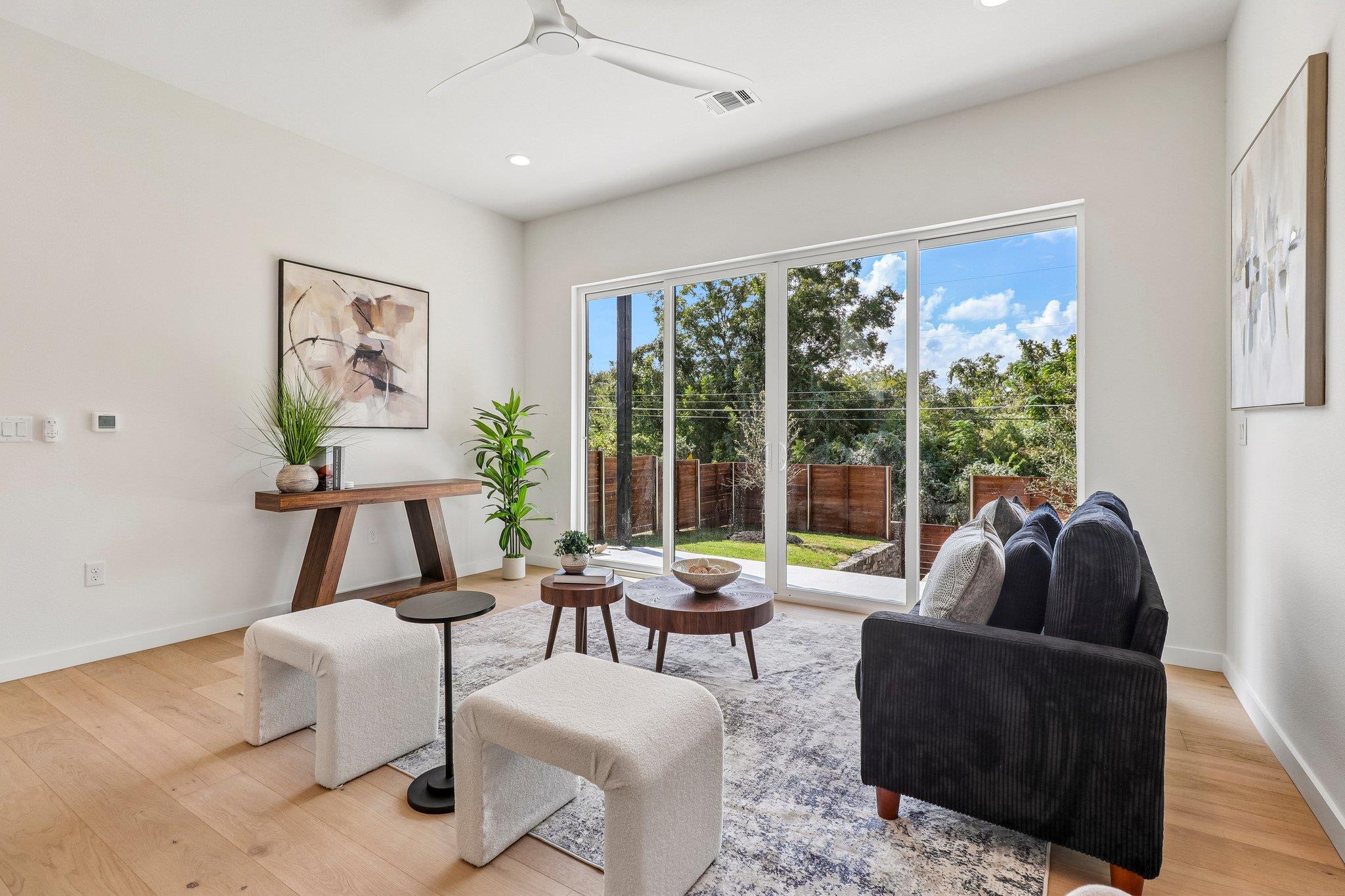 Sliding glass doors frame verdant backyard views 