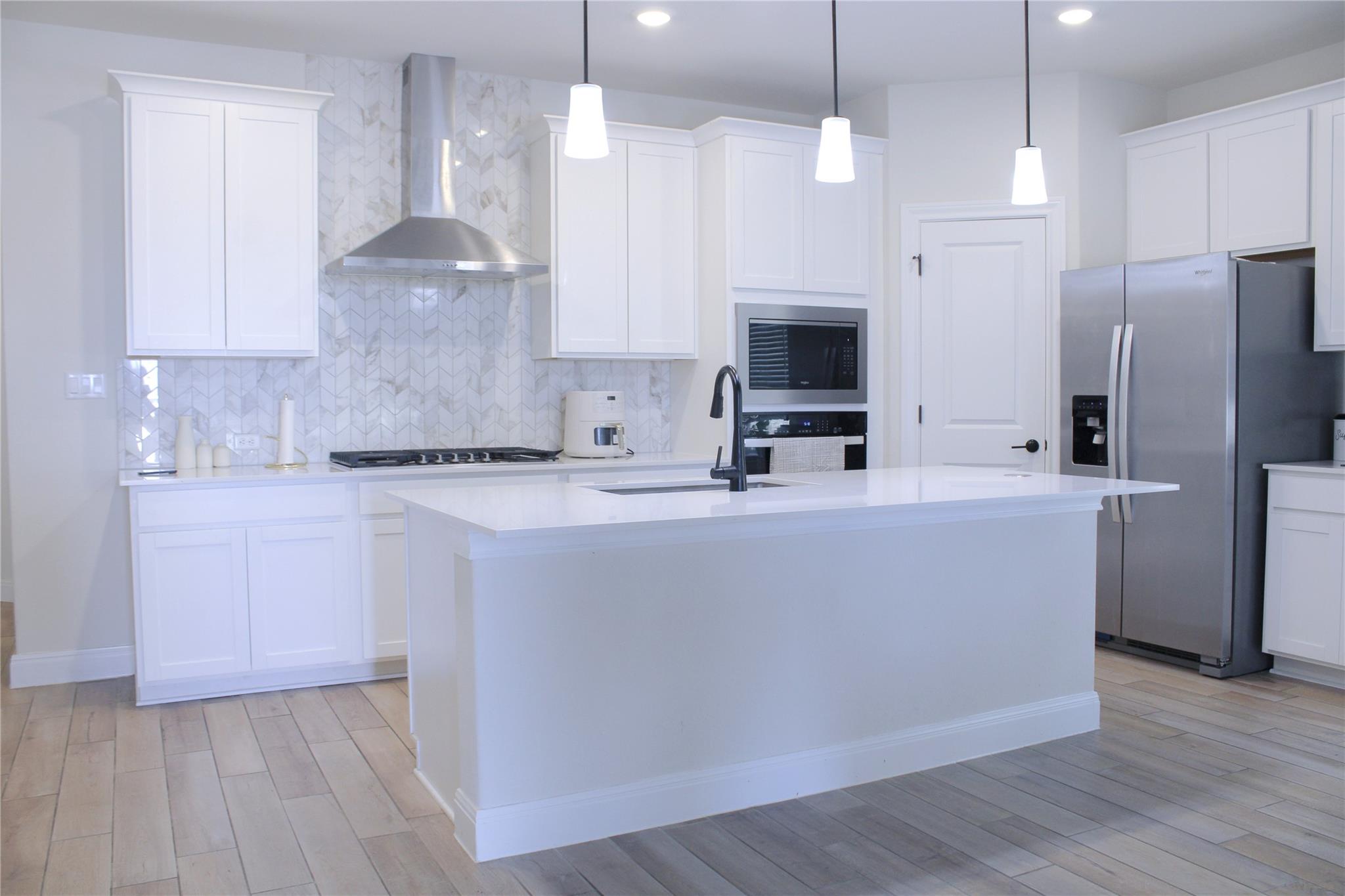 An open kitchen showcases a central island, shake