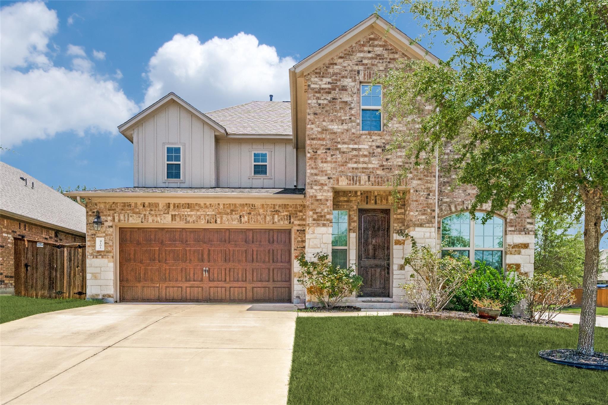 A classic brick exterior and concrete driveway de