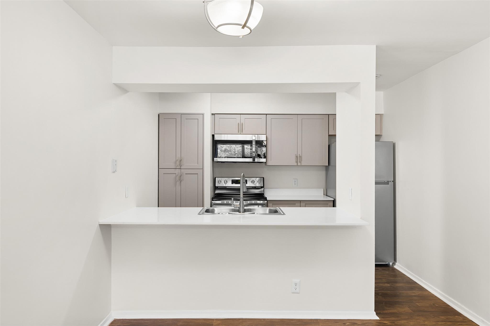 Gleaming stone countertops frame an open peninsul