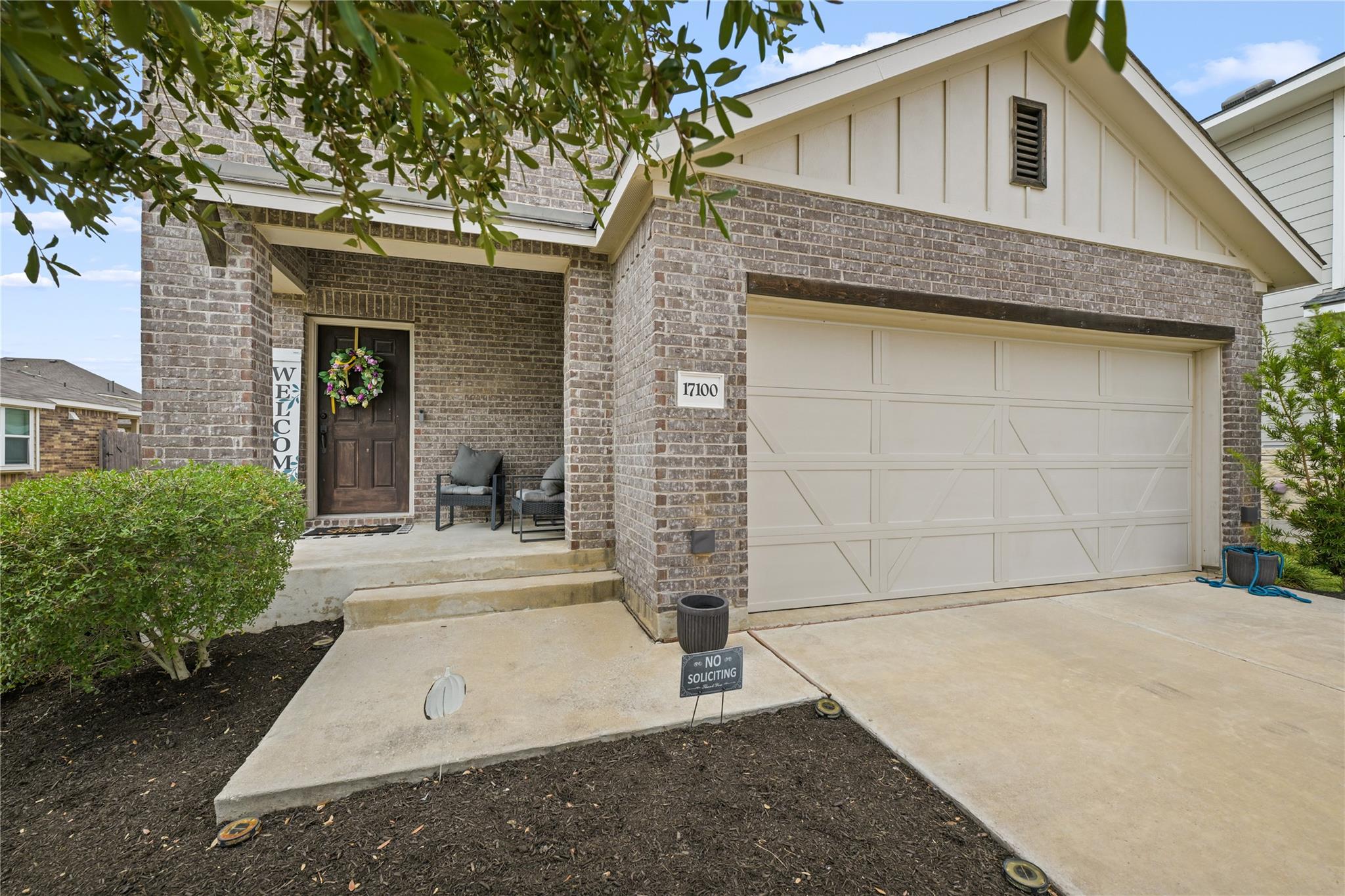 A welcoming front entry features timeless brickwo