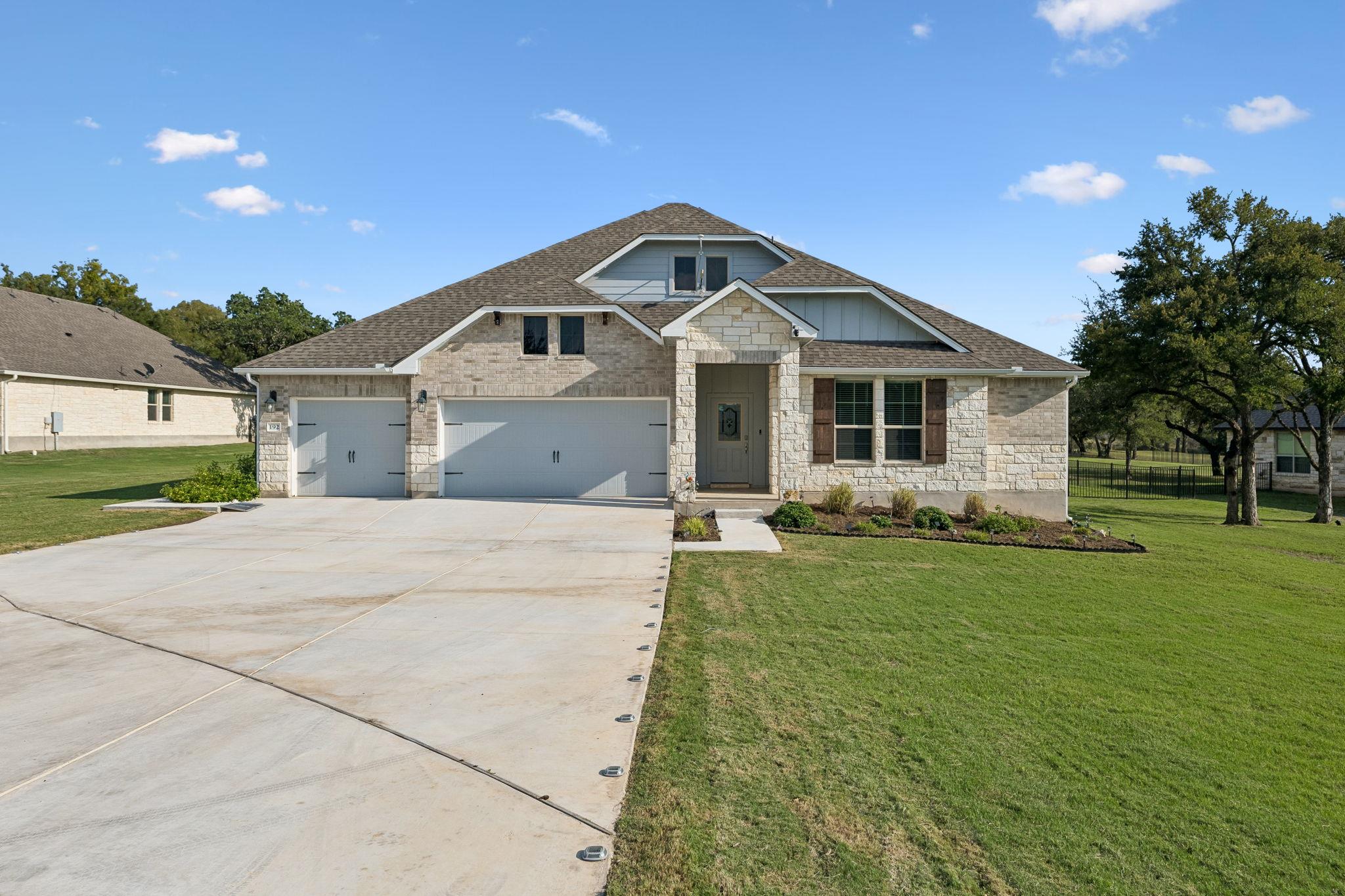 An inviting stone and brick facade accents this m