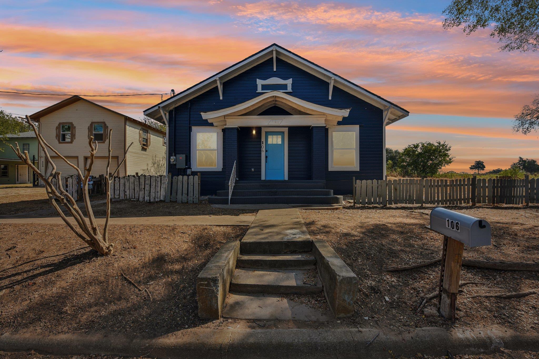 An inviting front porch with concrete steps leads