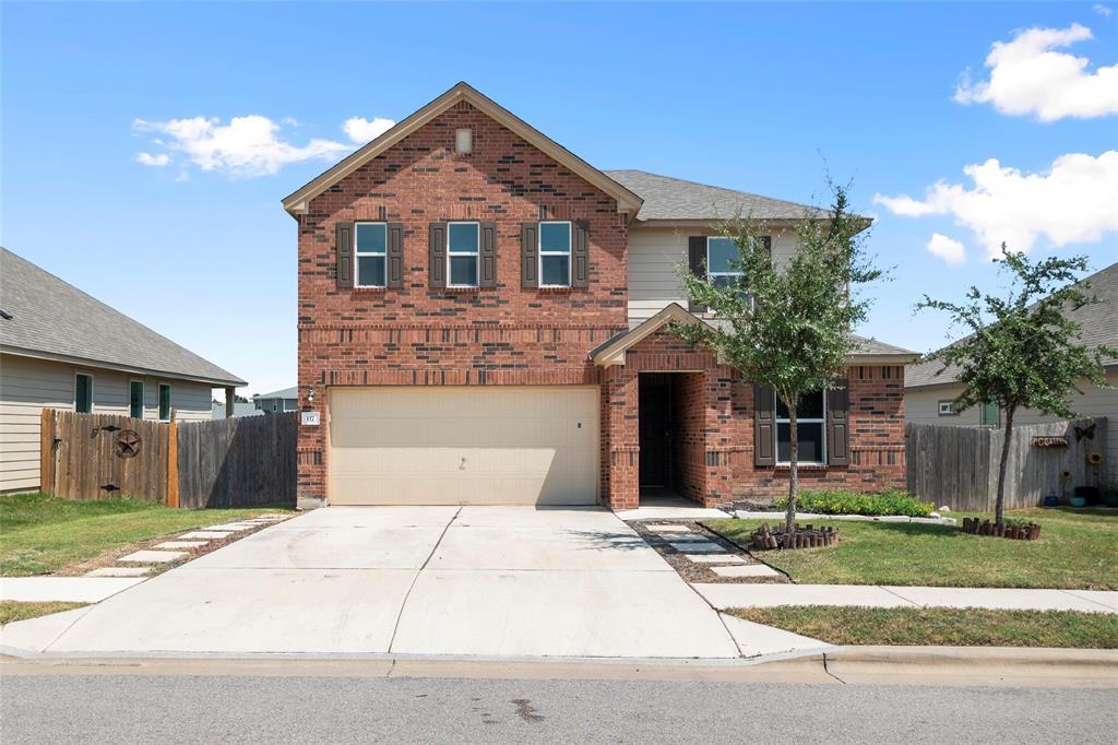 Classic brick exterior and a wide concrete drivew