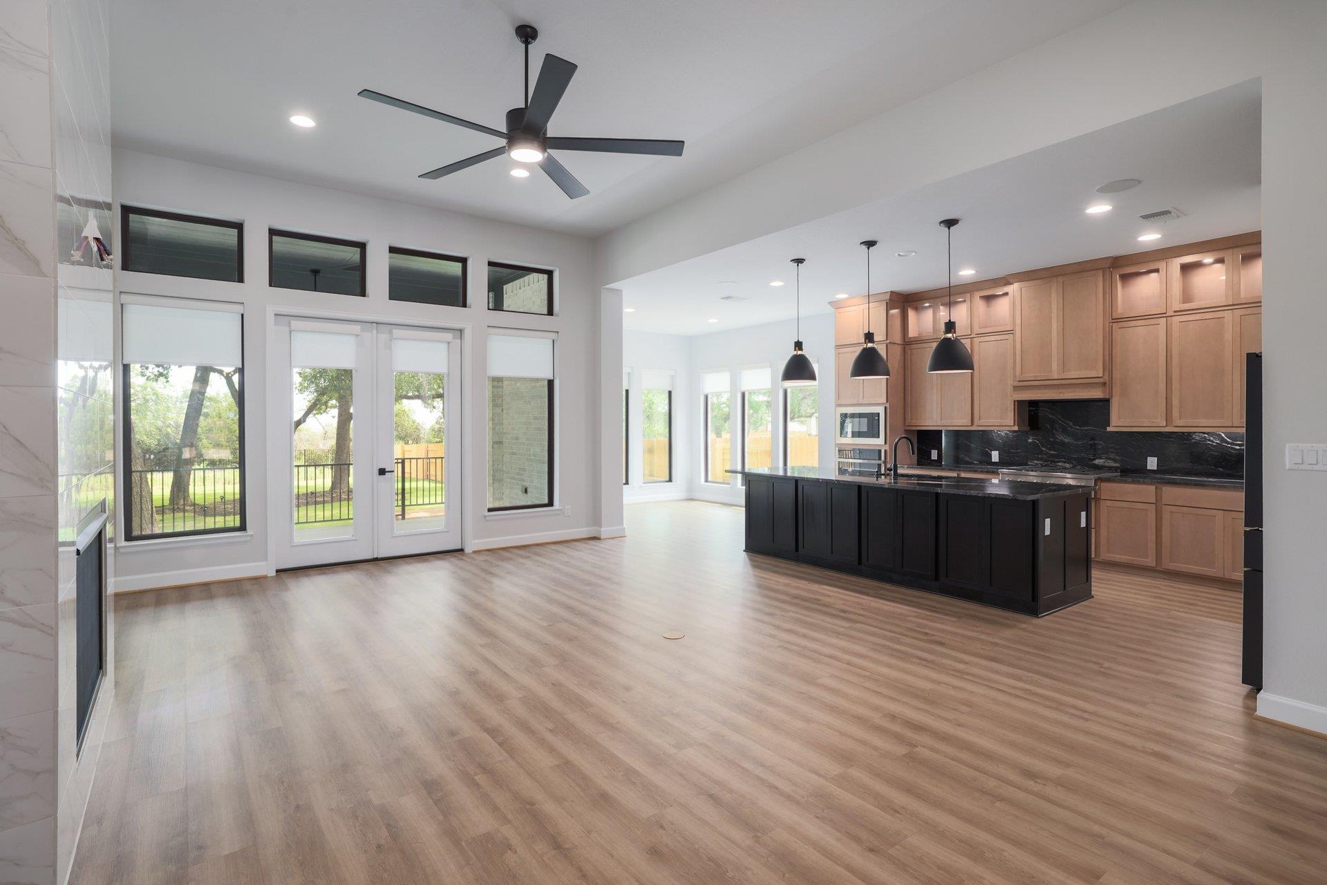 A spacious open-concept interior features wood fl