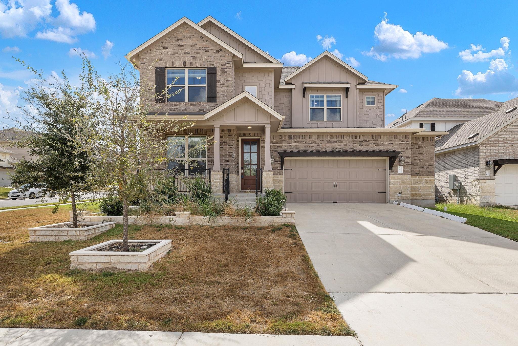 Stately brick and siding accents frame this multi