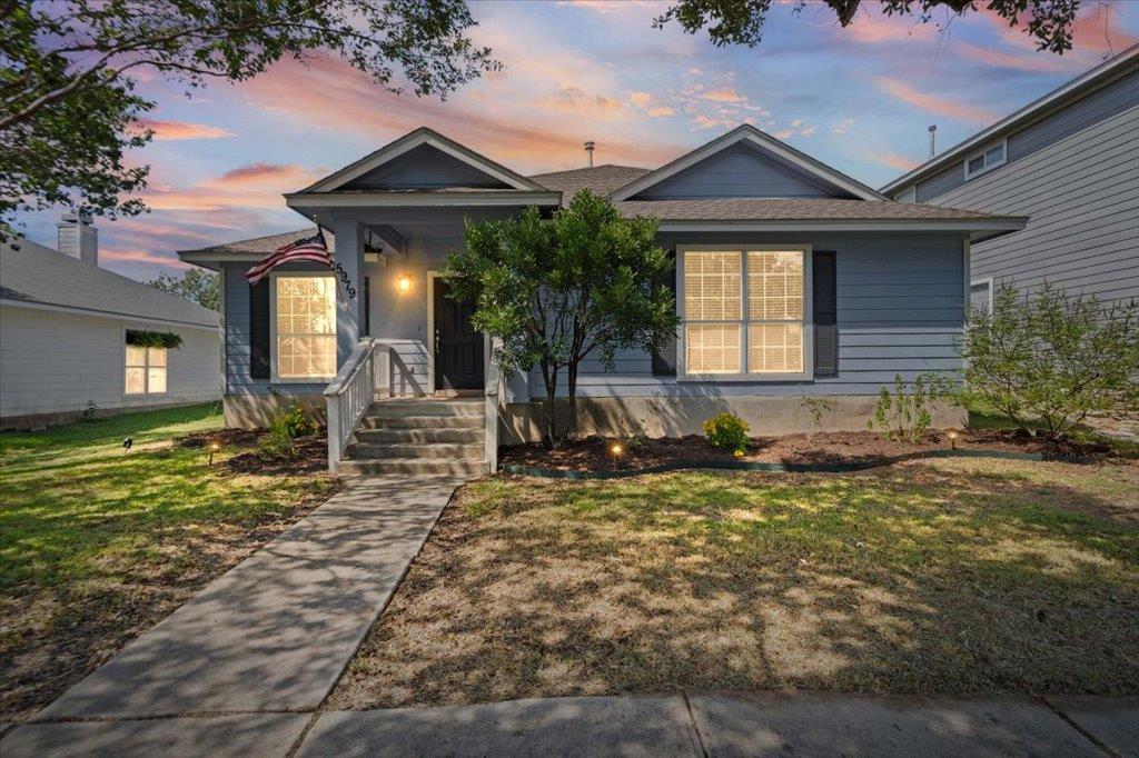 Welcoming front porch and a neat concrete walkway