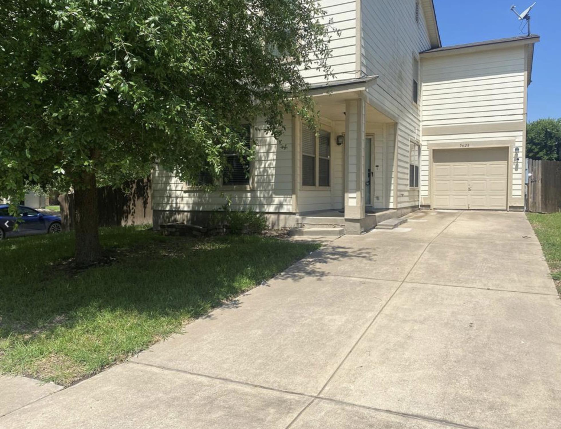 A spacious concrete driveway leads to the front p