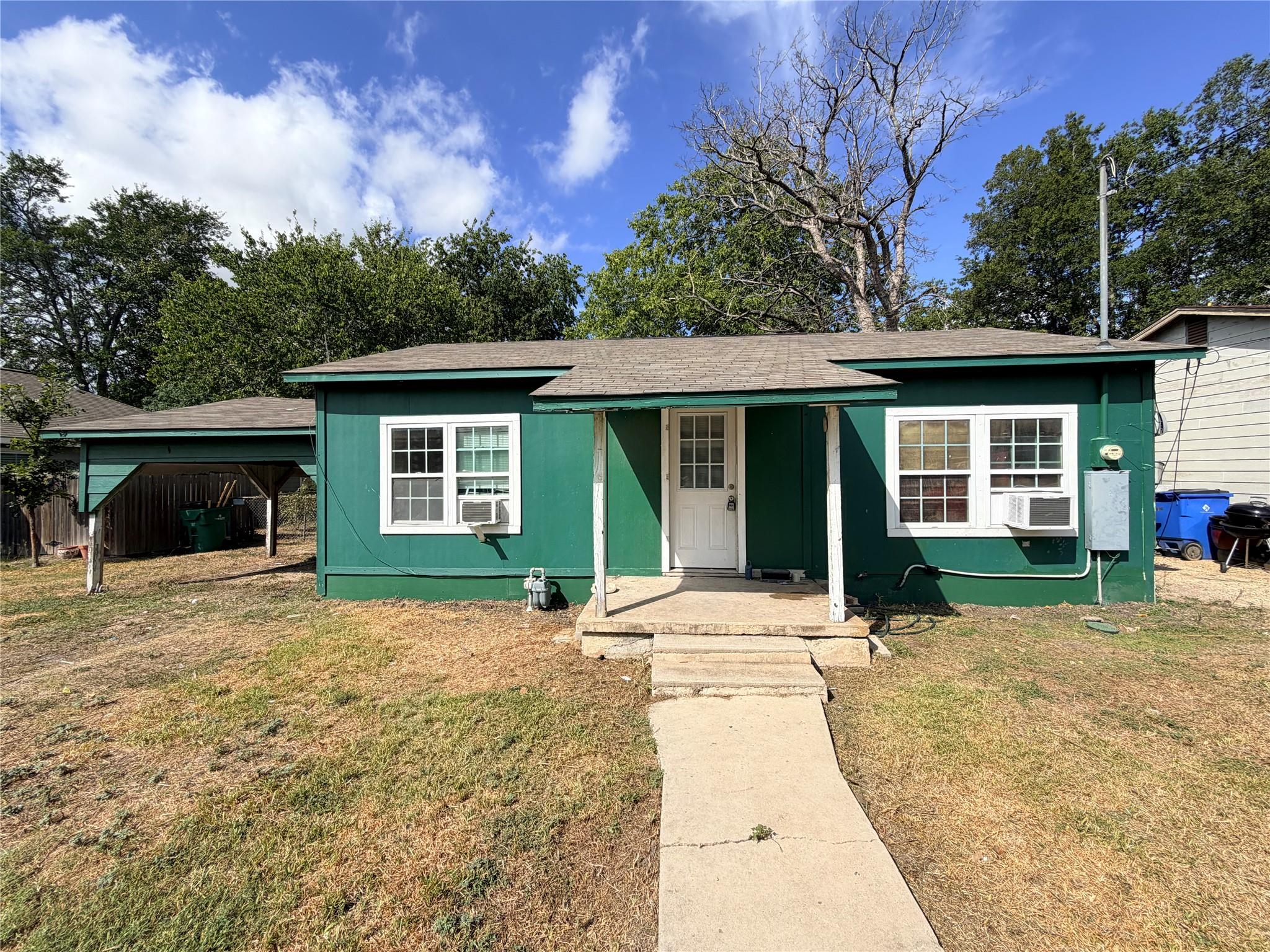 A concrete walkway leads to the covered front por