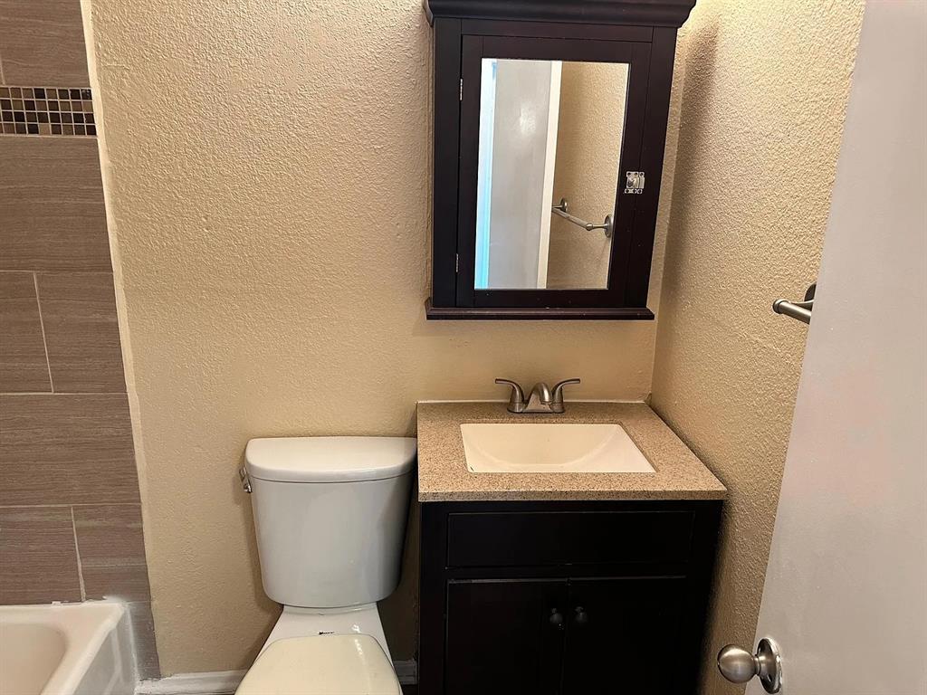 Granite counters and textured walls define this c