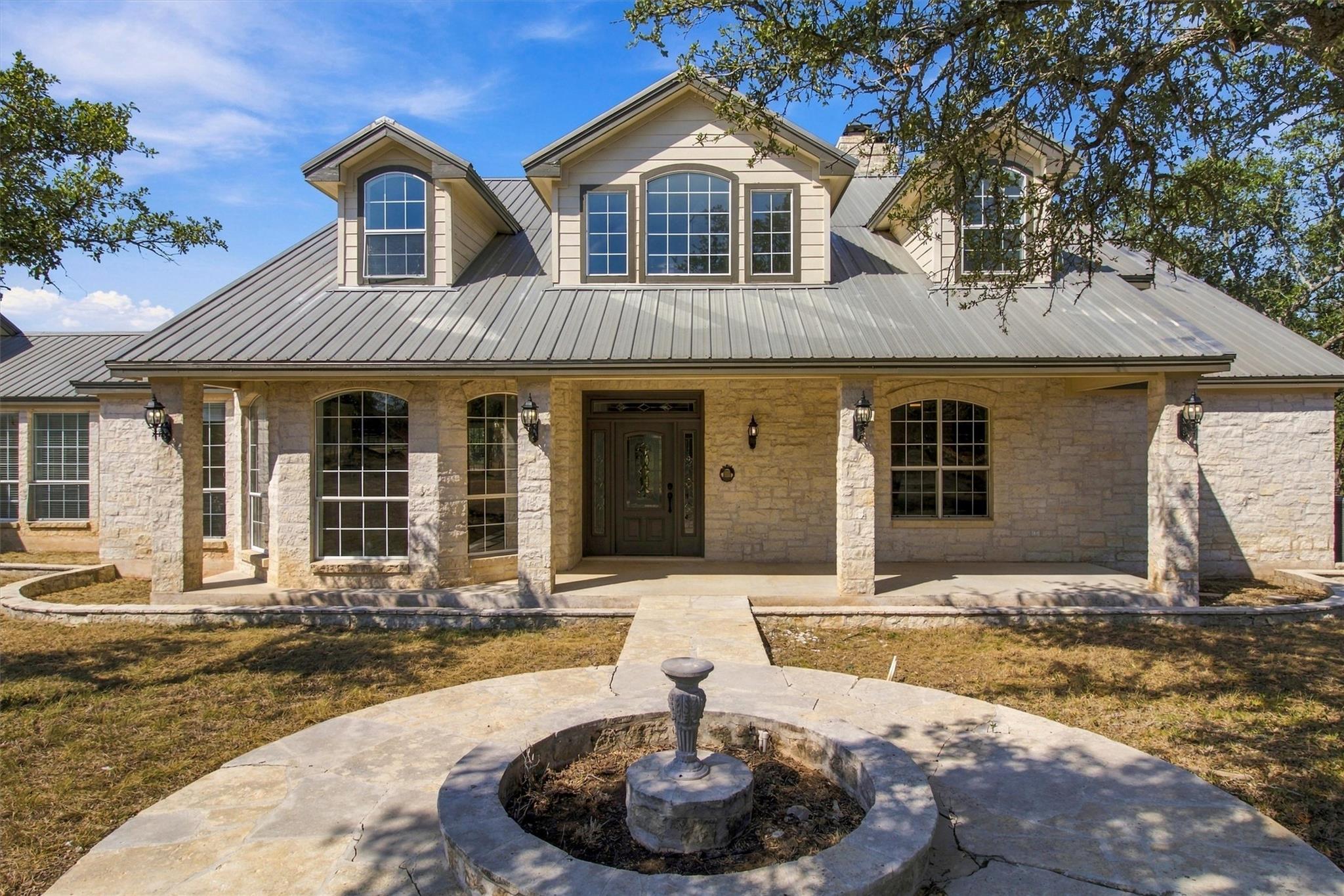 Limestone facade and a metal roof establish a cla