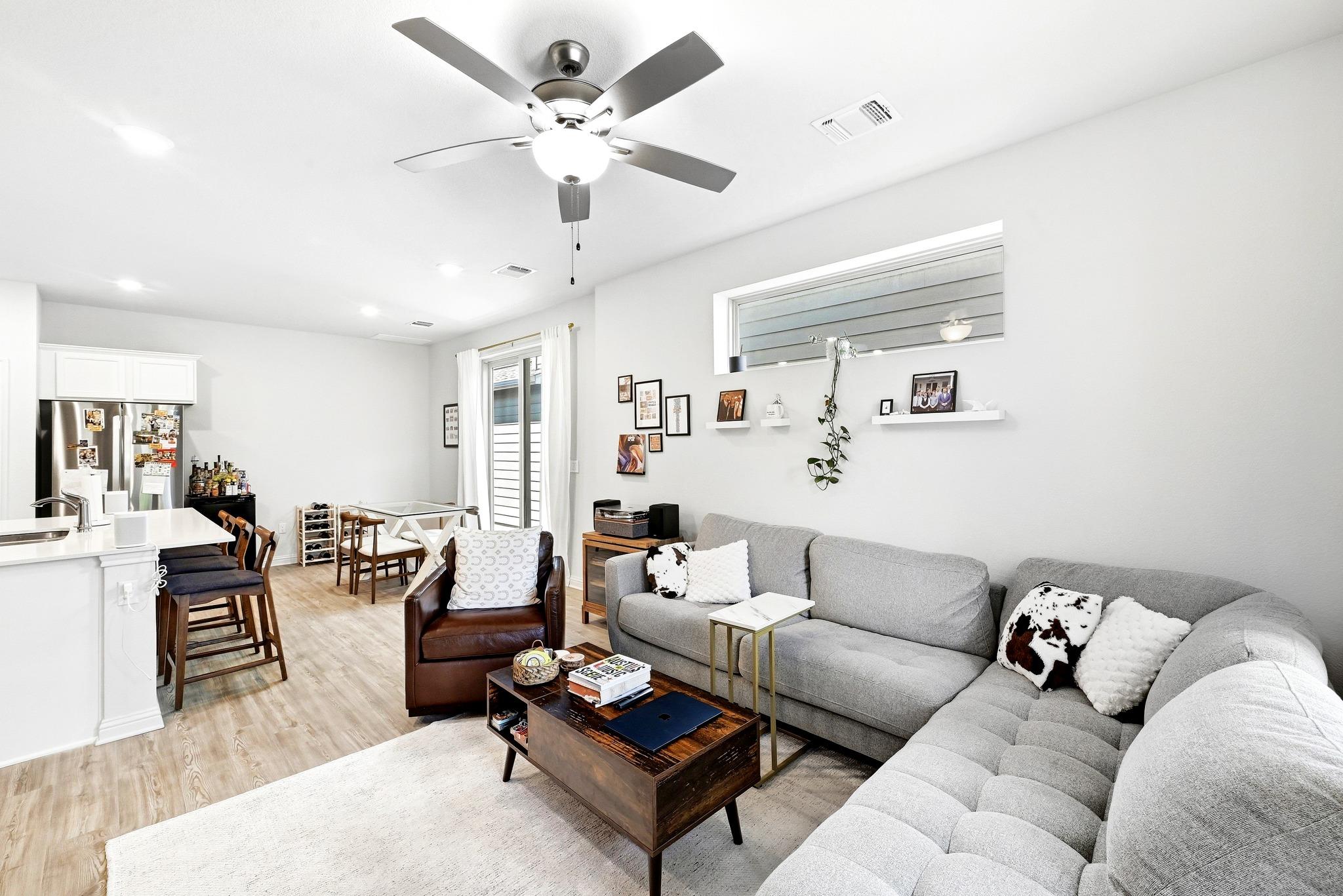 Recessed lighting and warm wood-style flooring an