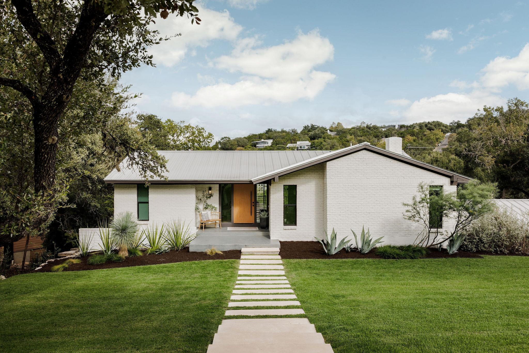 Crisp white brick and a modern metal roof define 