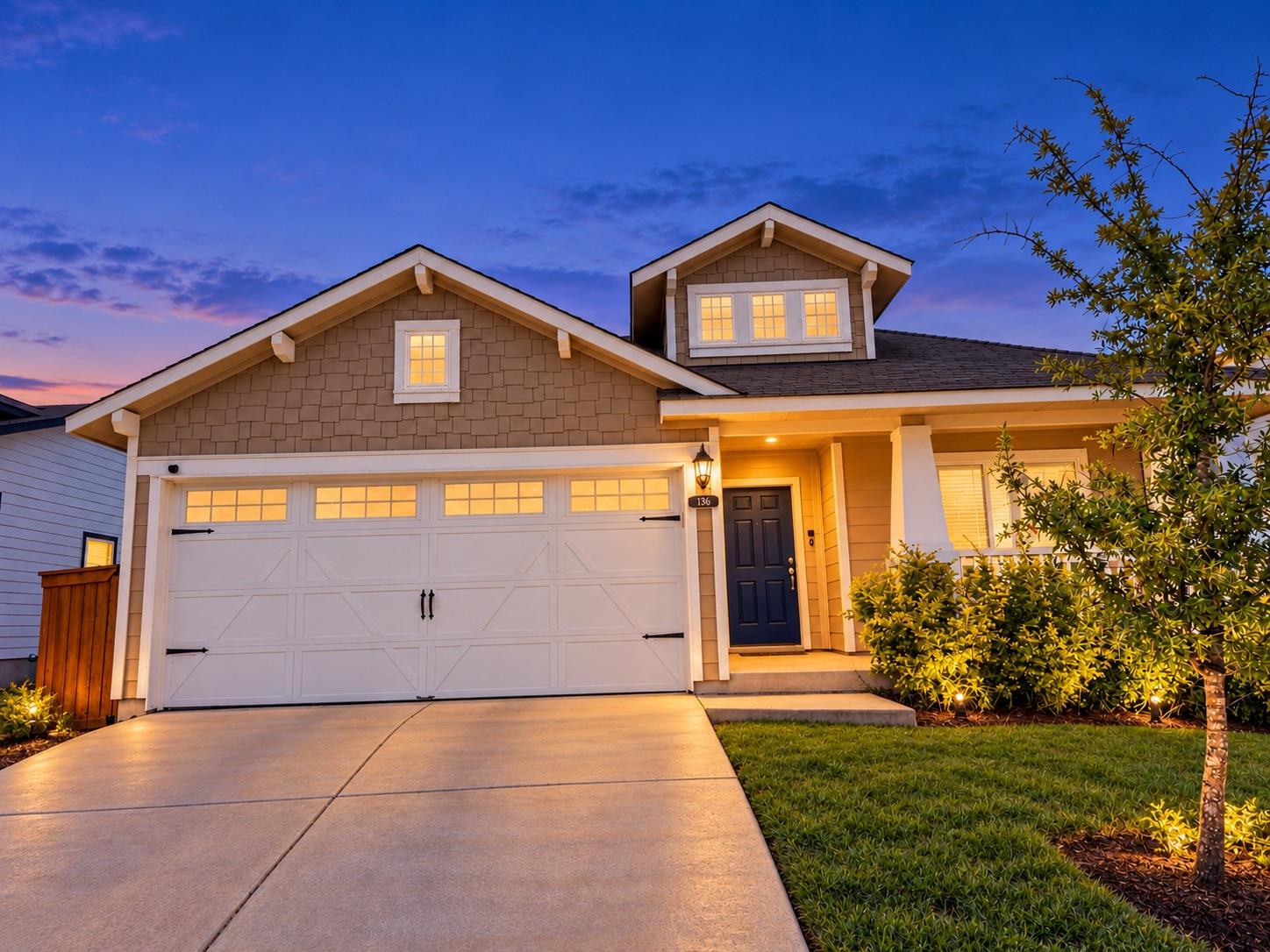 Gabled rooflines and a concrete driveway define t