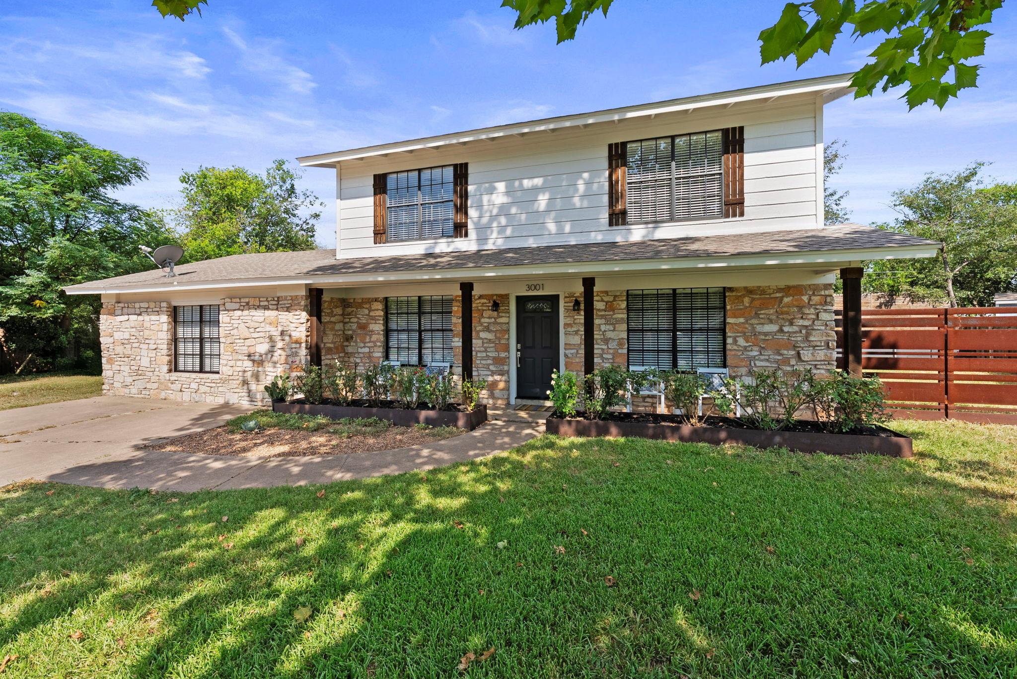 Natural stone accents and a welcoming front porch