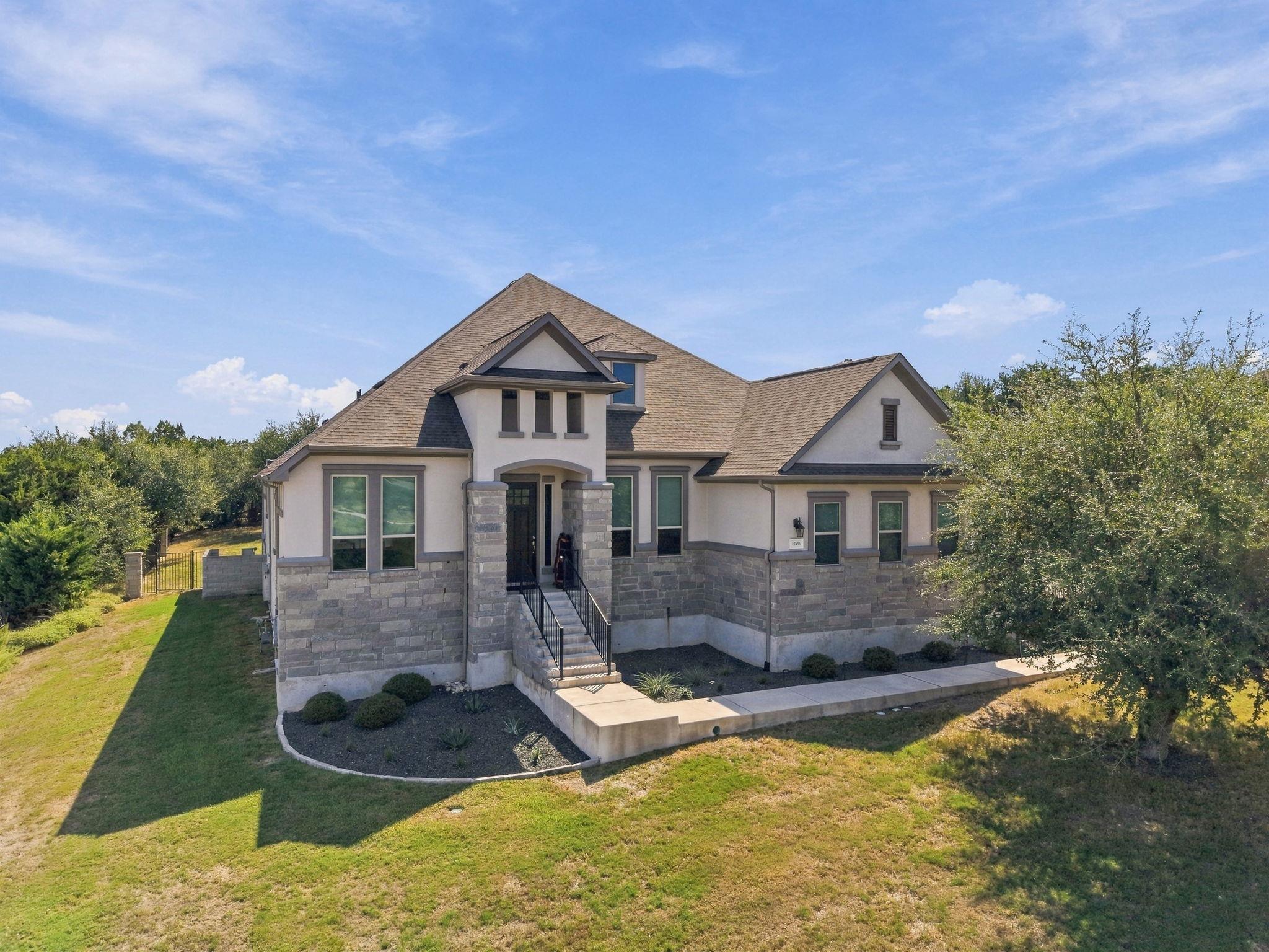 Striking stone and stucco masonry defines this cu