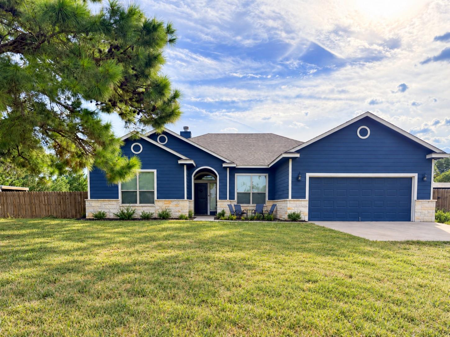 A spacious green lawn borders this contemporary h