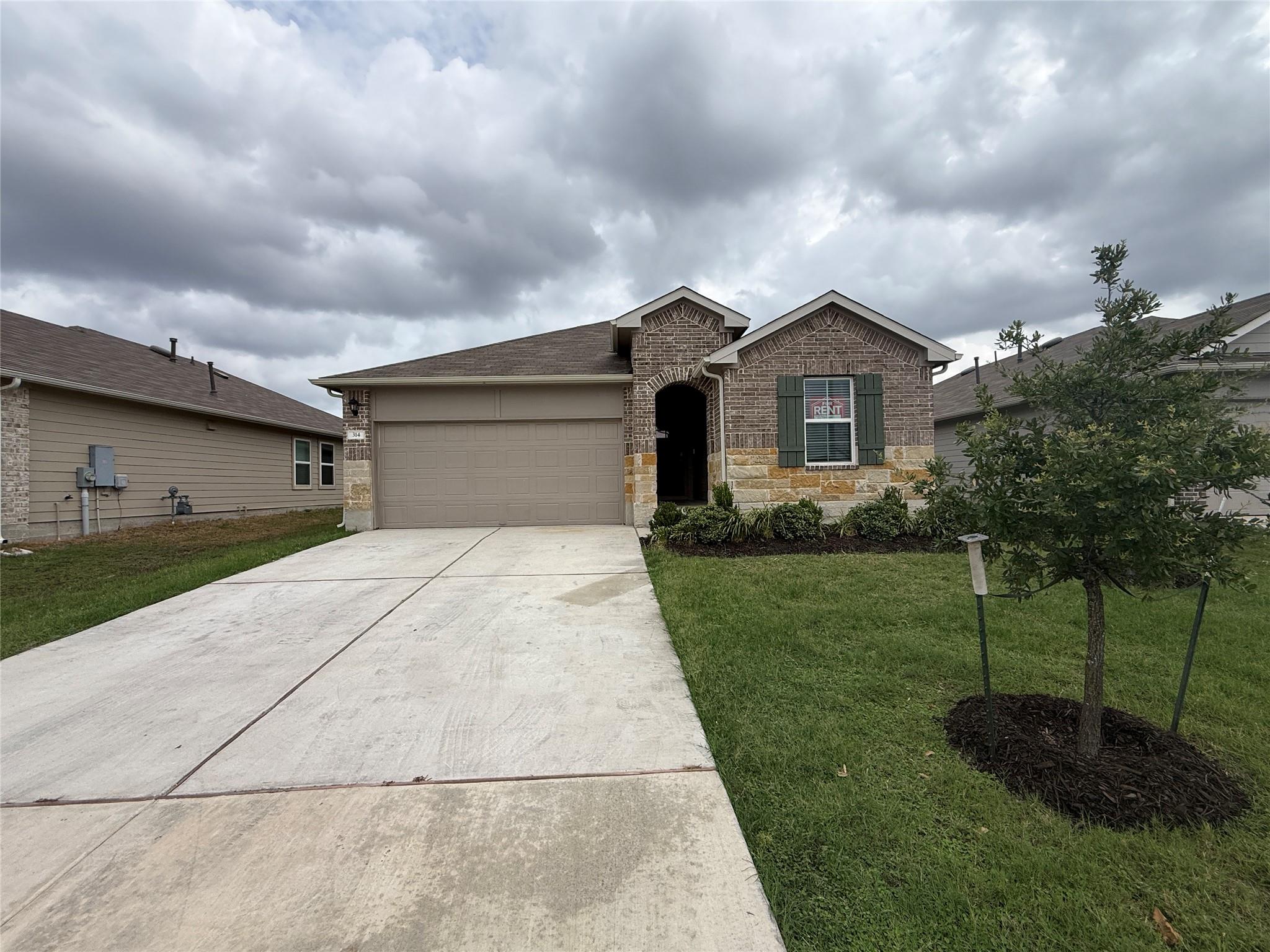 A classic brick exterior and a concrete driveway 