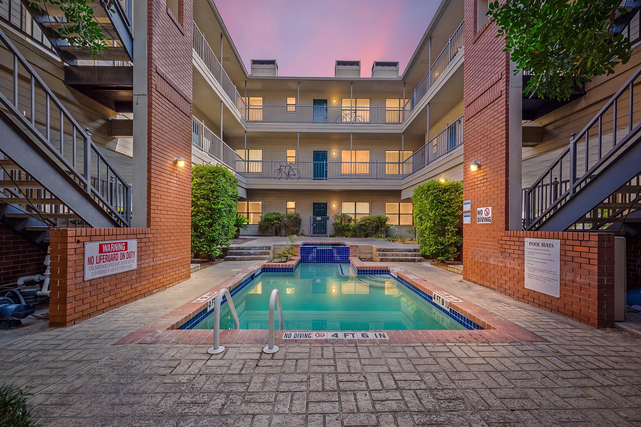 A central courtyard features a sparkling swimming