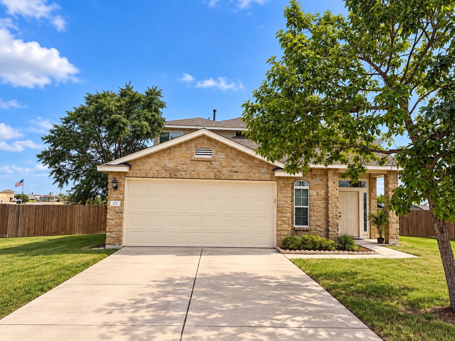A classic stone facade and tidy concrete driveway