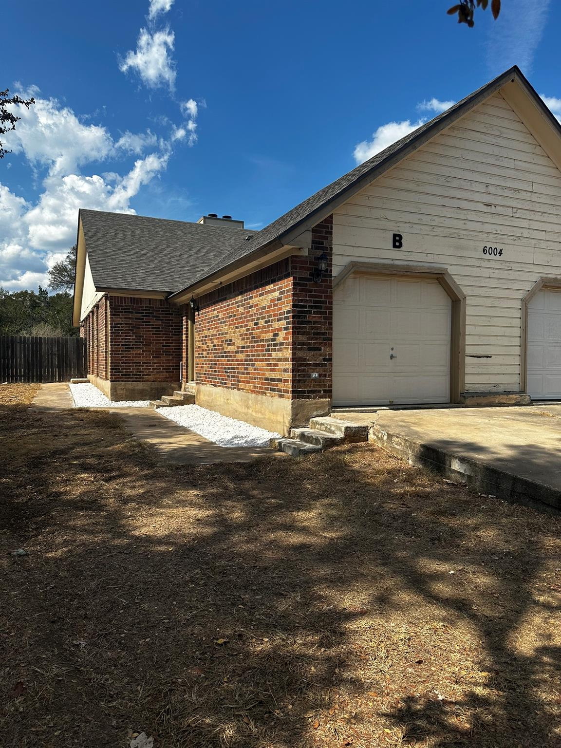 Brick and wood siding elements define the exterio