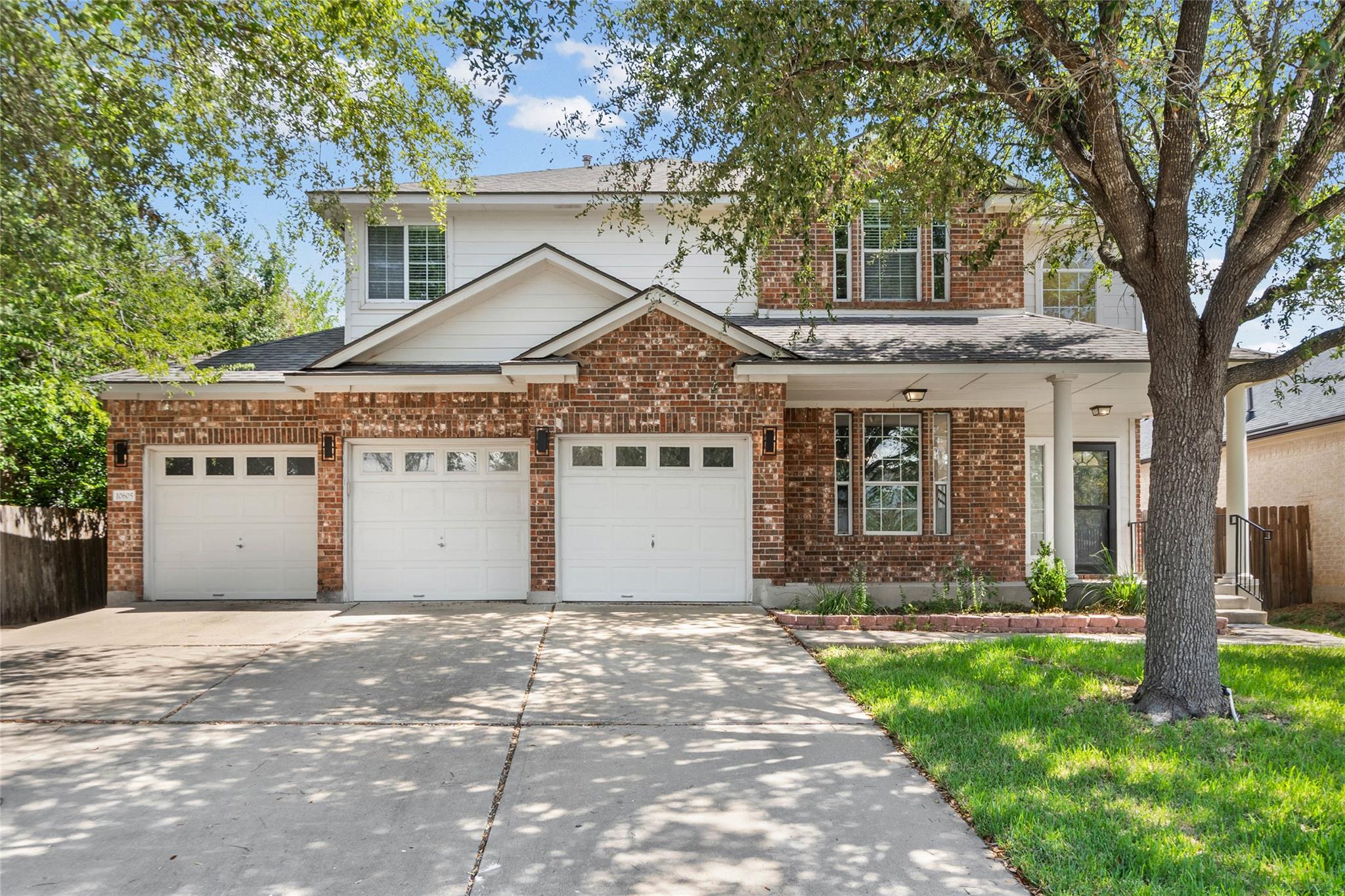 Classic brick and siding accents frame a spacious