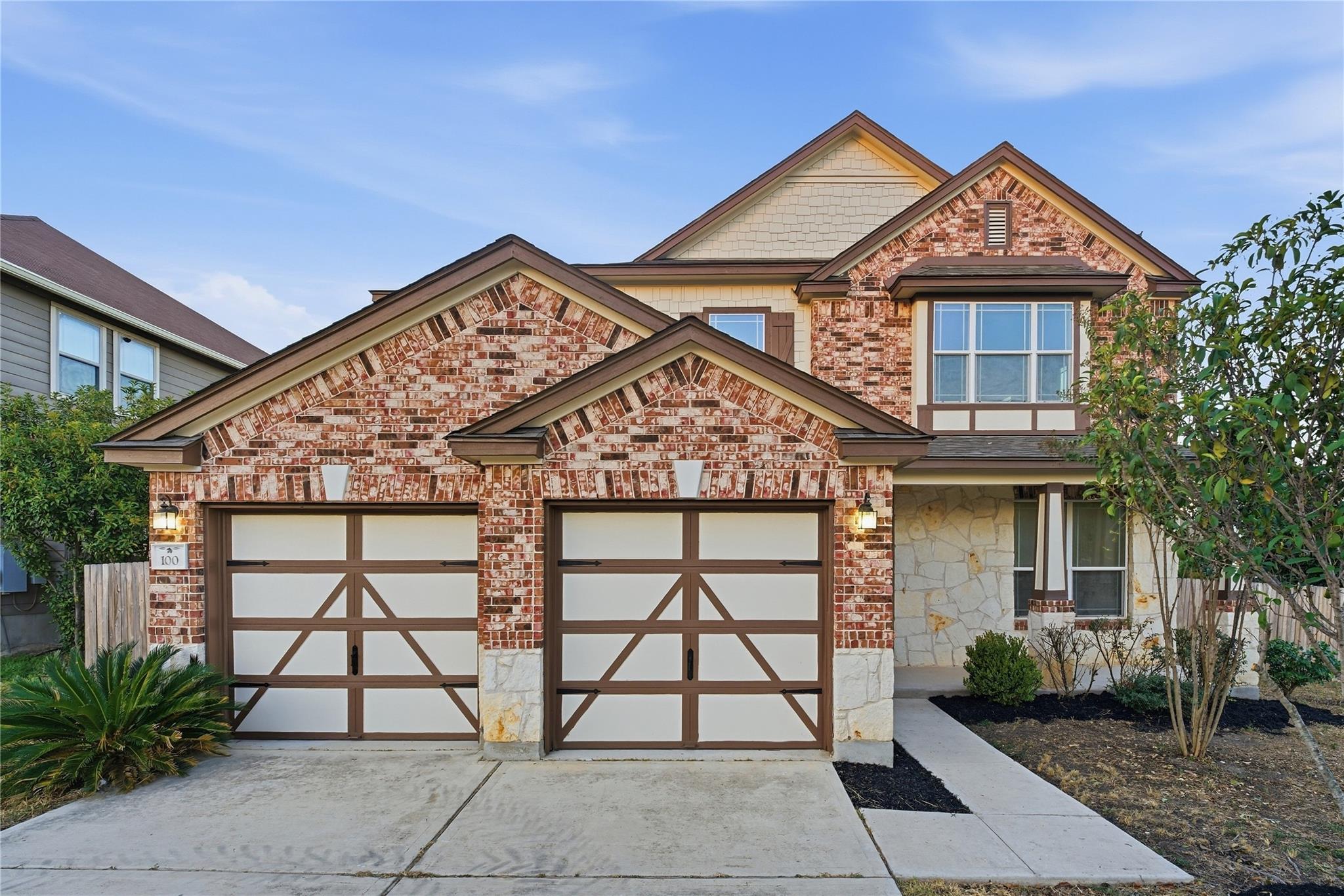 Multi-textured masonry and bold rooflines define 