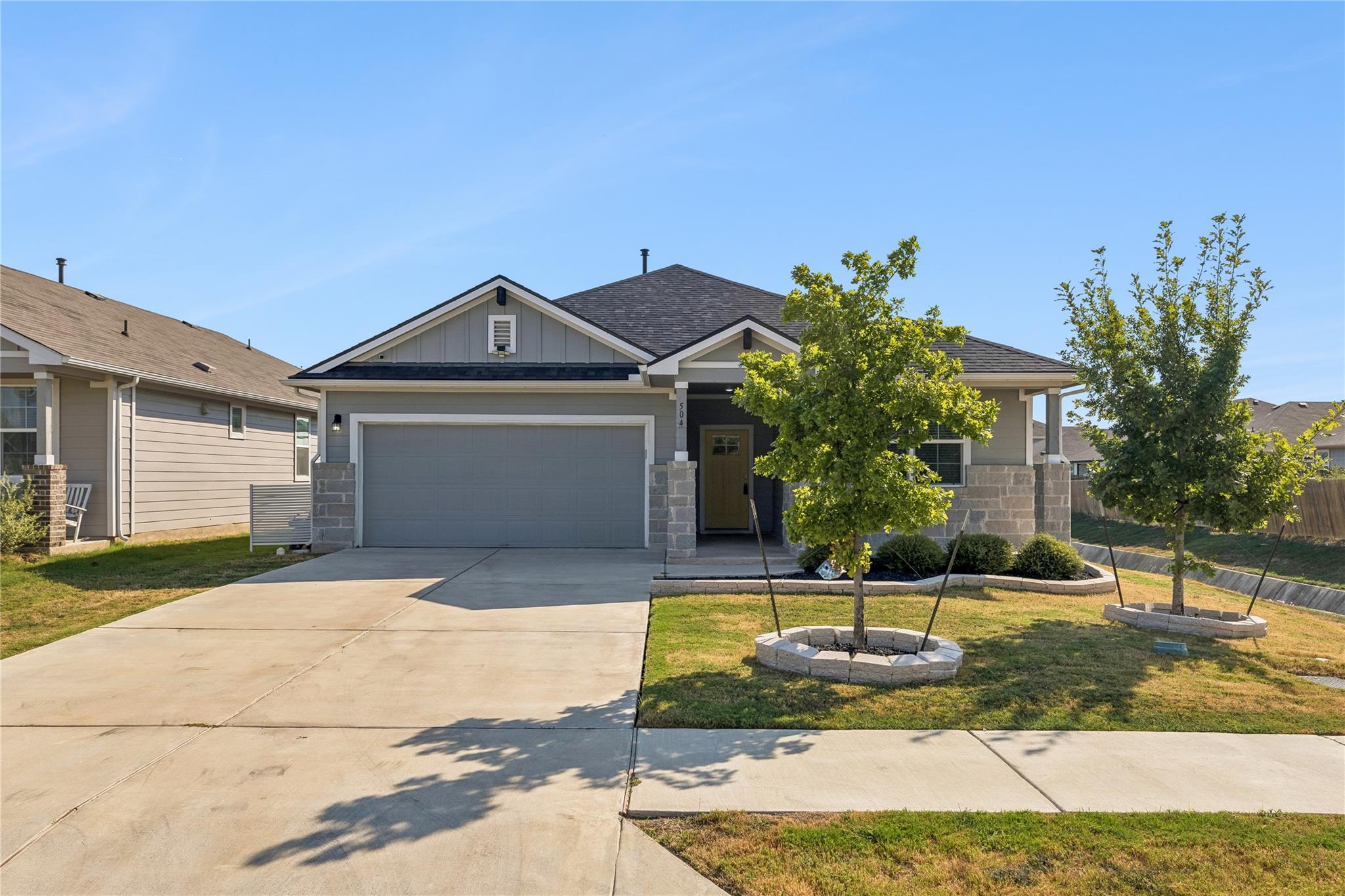 Clean lines and a spacious driveway define this m