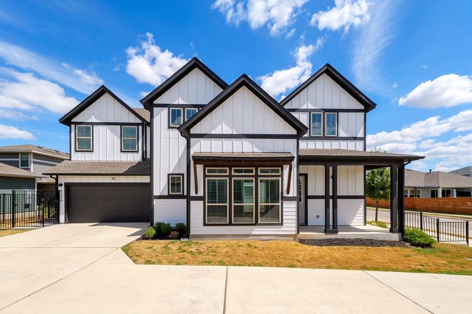 Gable rooflines and dark trim create striking cur