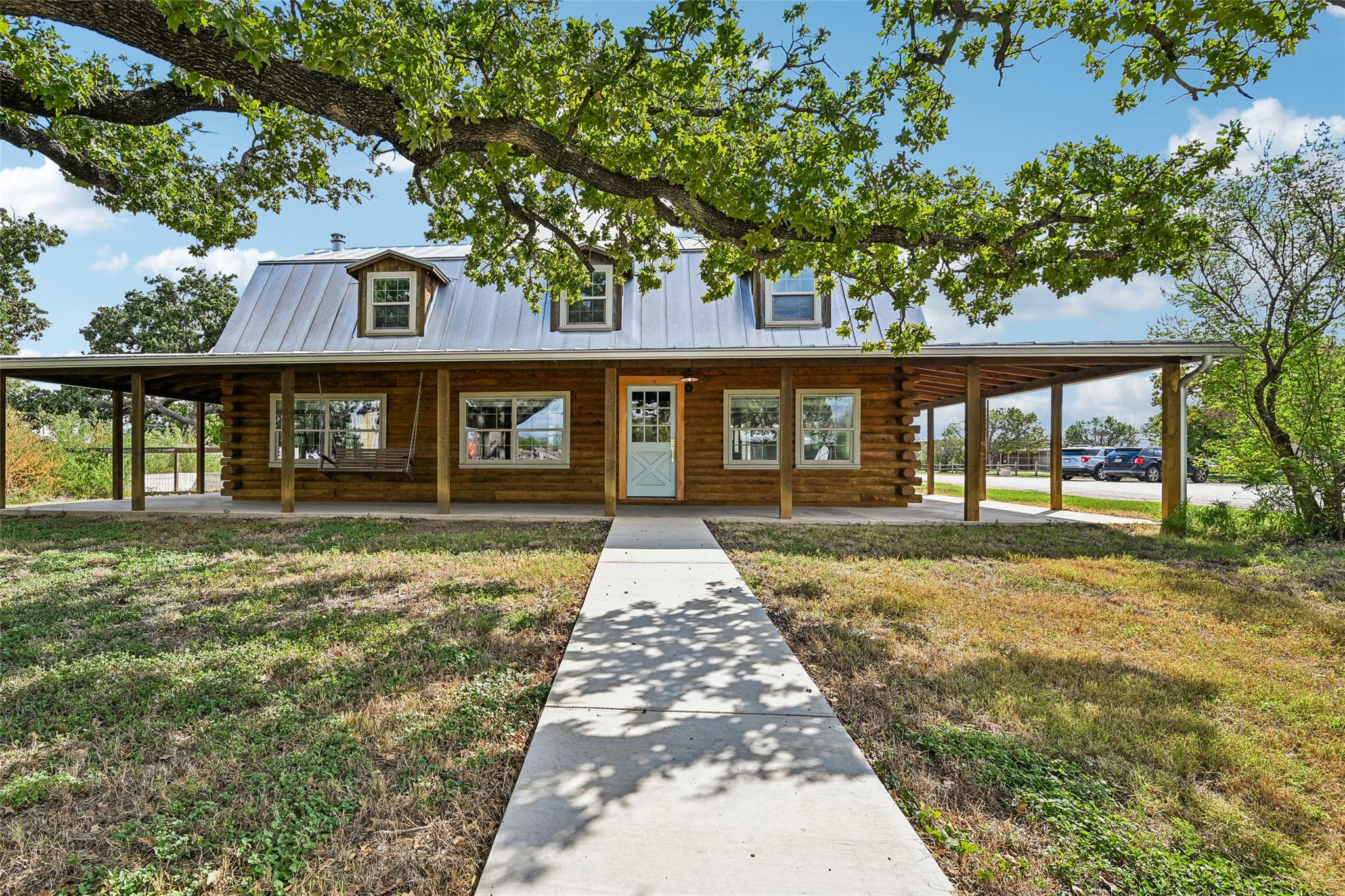 Mature oak trees shade a welcoming front porch an